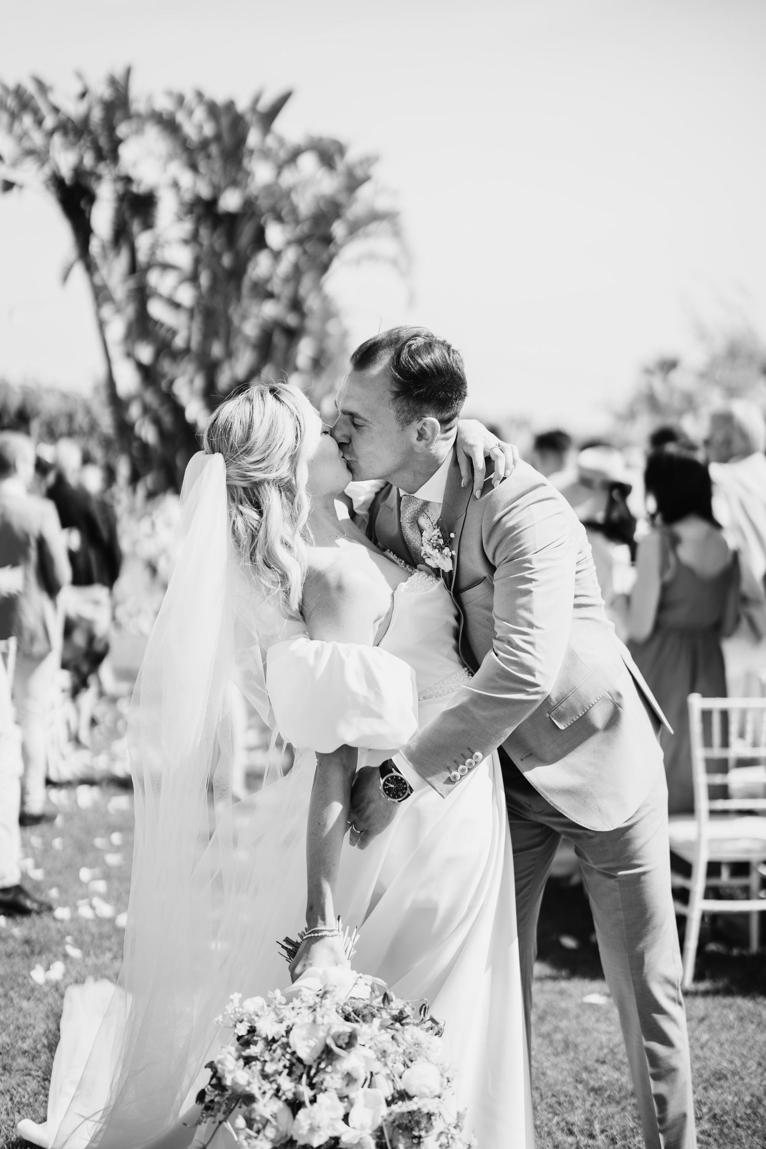 Black and white wedding photography captures intimate moments during outdoor celebration.