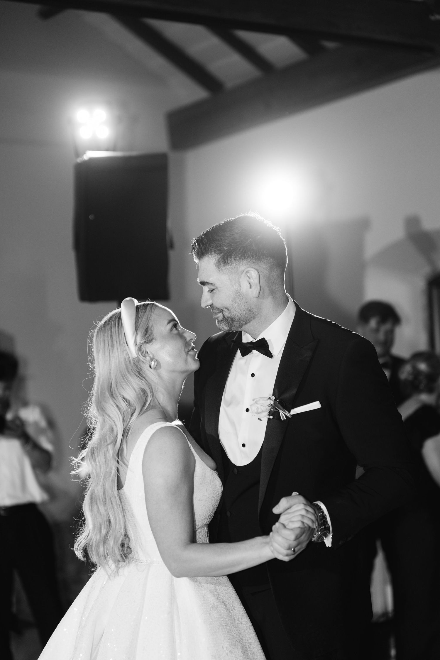 Black and white photo of couple's first dance at wedding reception.