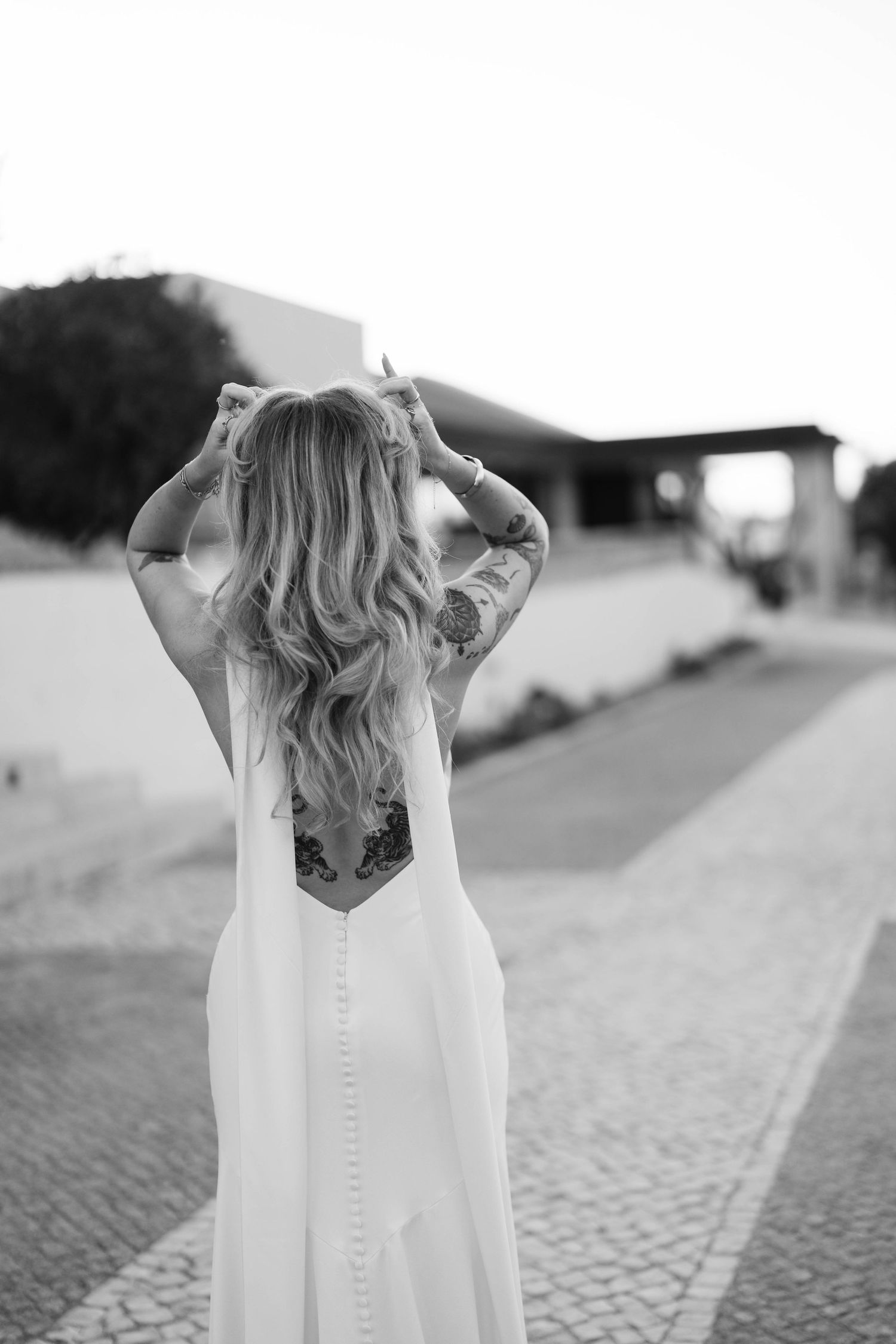 Back view of a bride in a white dress with button details.