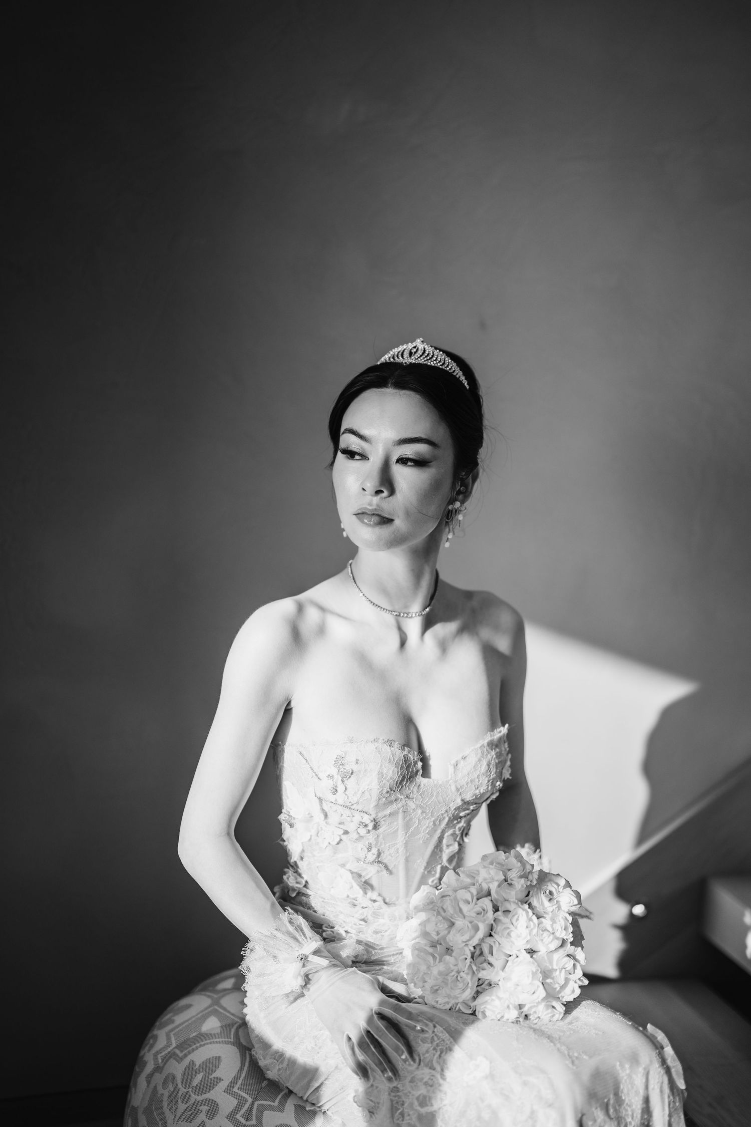 Classic black and white portrait of elegant bride in lace gown and tiara.
