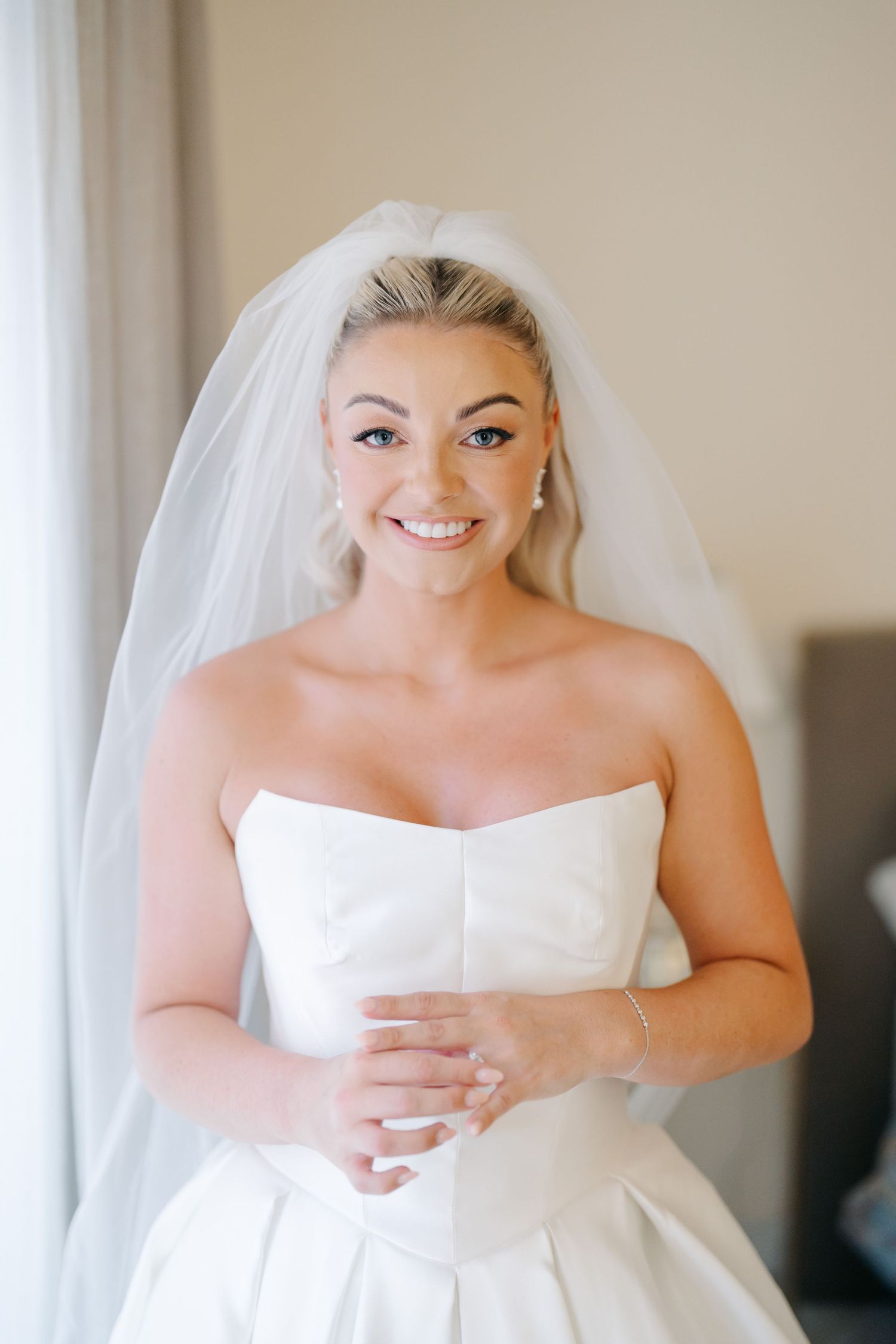 Close-up shots of bridal preparations showing classic white wedding gown details.