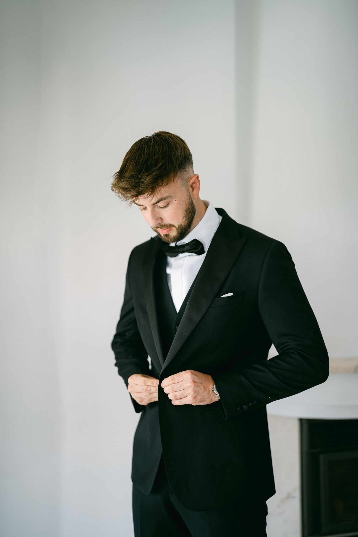 groom walking wedding venue portrait