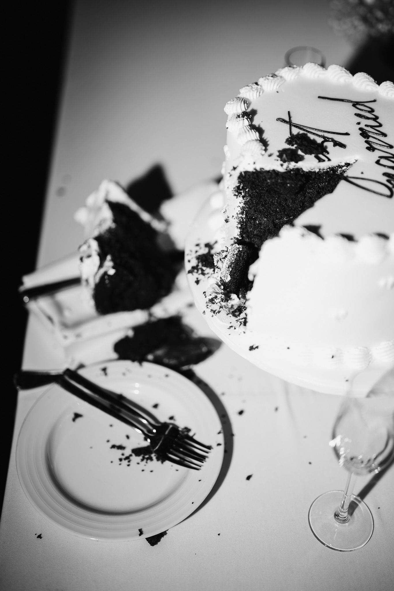 Black and white sequence showing a slice of cake being eaten from a white plate.