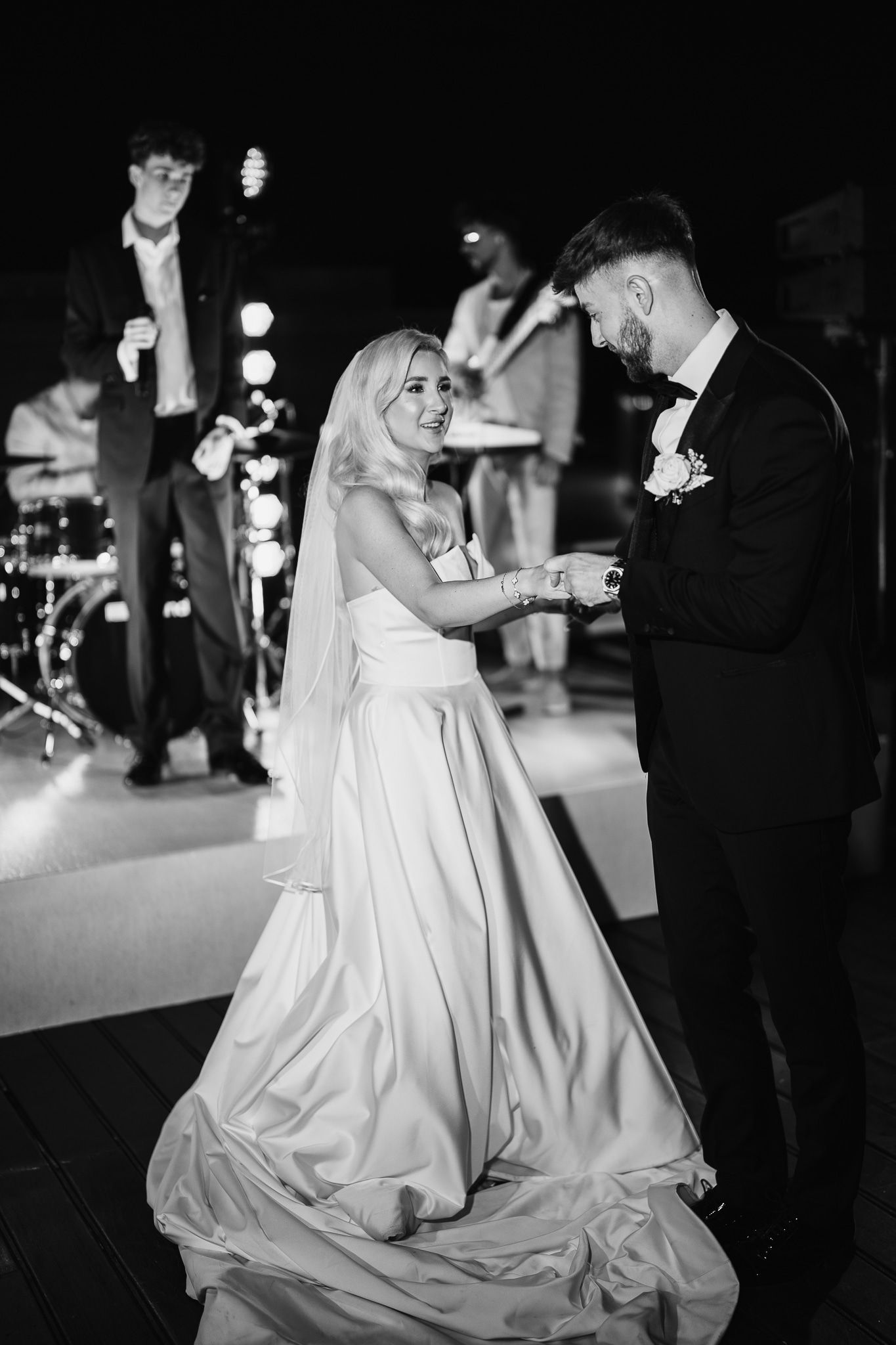 Elegant couple dancing at a wedding reception with flowing white dress.