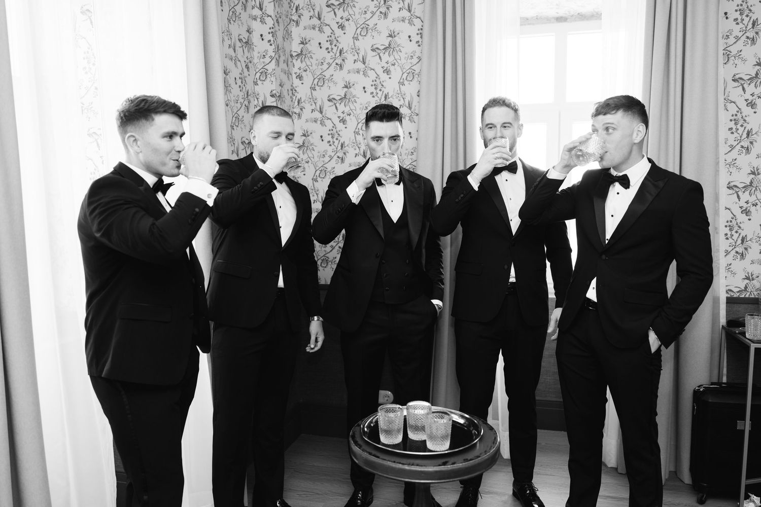 Group in formal attire taking drinks together in an elegant room.
