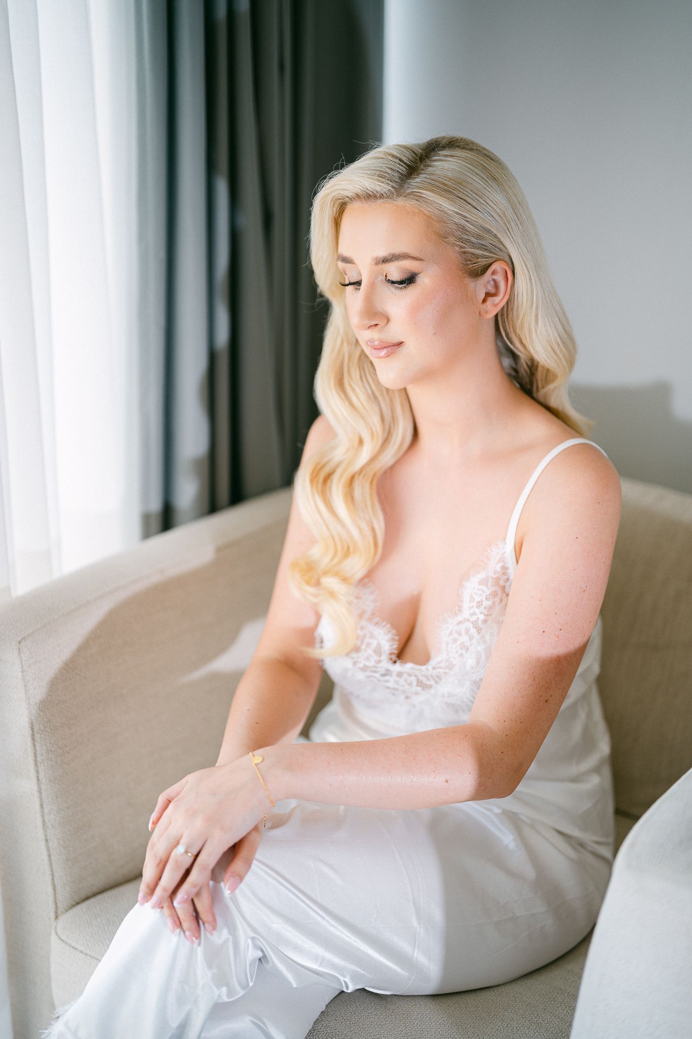 Romantic boudoir photo series with natural window light and elegant poses.