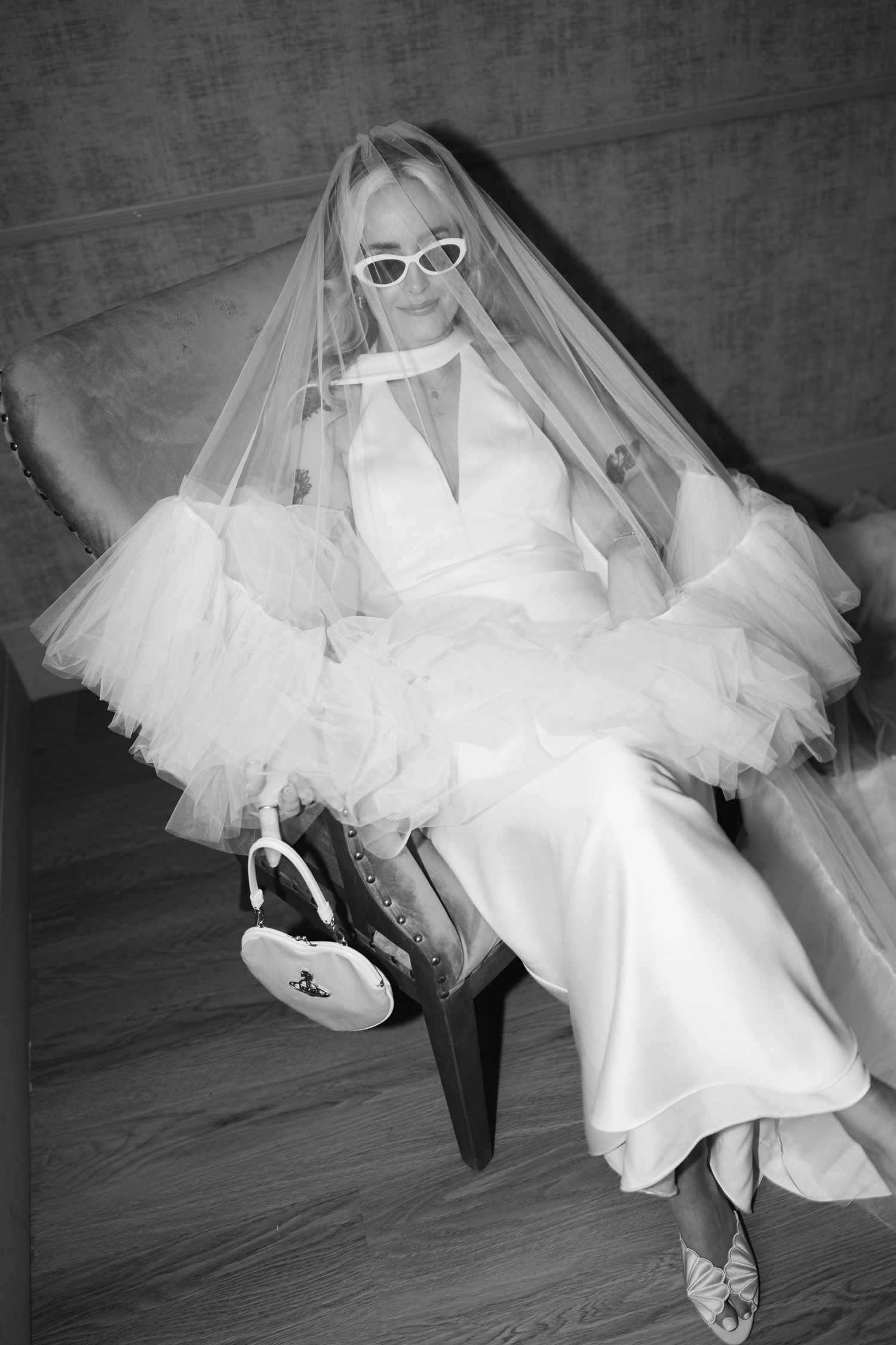 bride putting on wedding dress