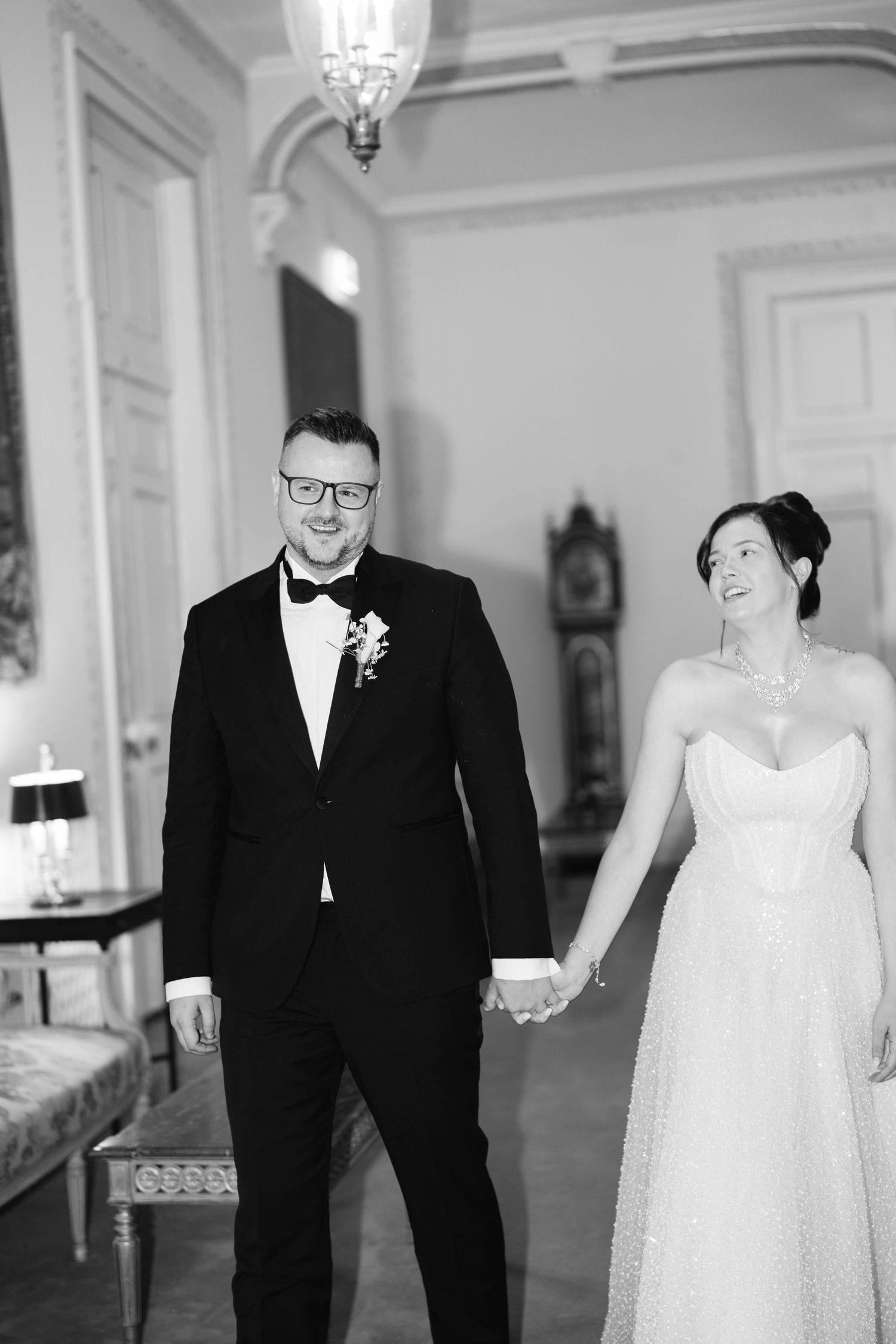 Black and white photo series showing joyful moments between a couple on their wedding day.