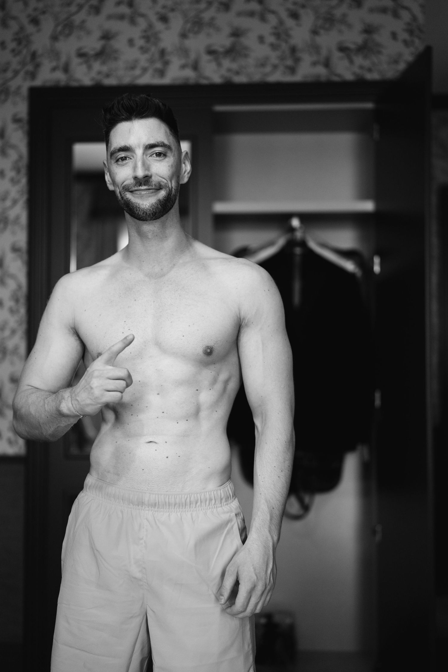 Black and white photo showing preparation moments before a formal event.