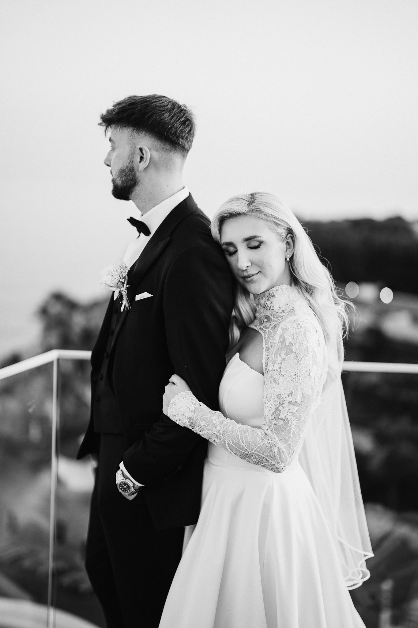Intimate black and white portraits showcase tender moments between newlyweds during sunset session.