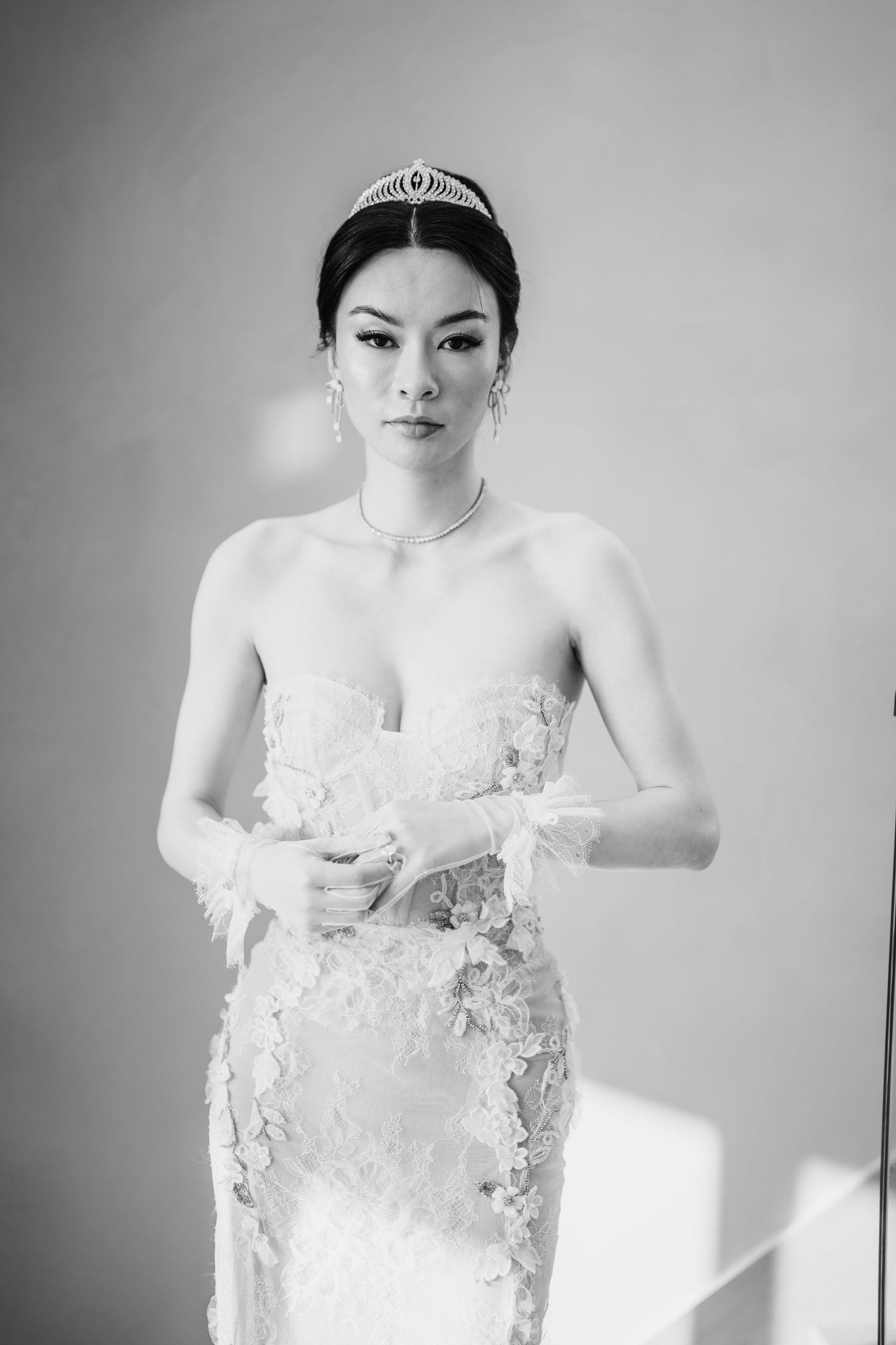 Black and white candid bridal portrait showing detailed lace wedding gown.