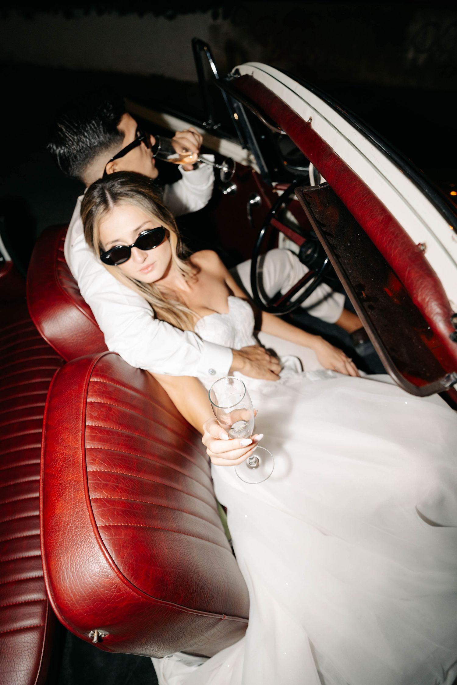 bride and groom inside classic wedding car