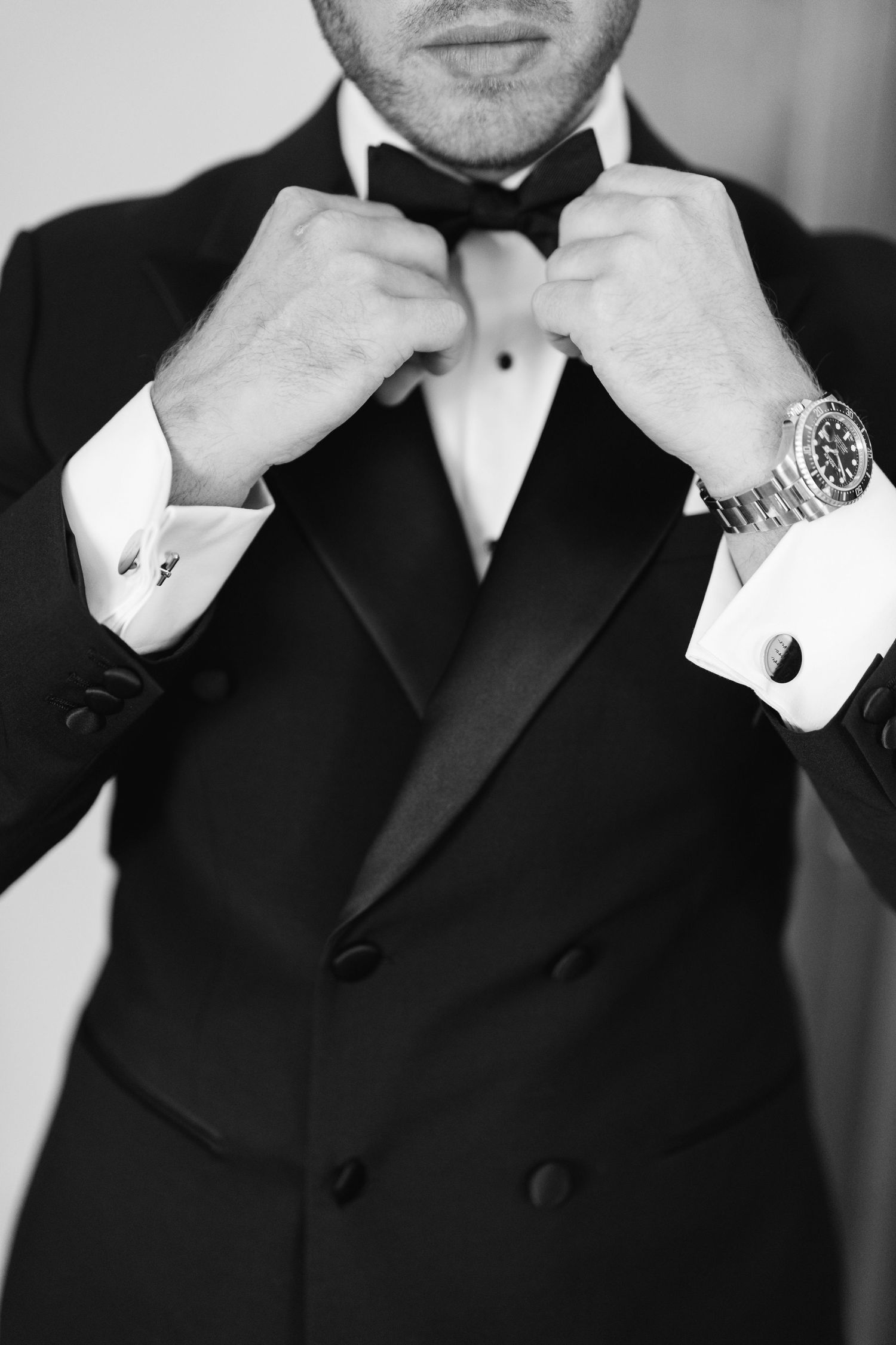 Close-up shots of formal tuxedo and bow tie adjustments.