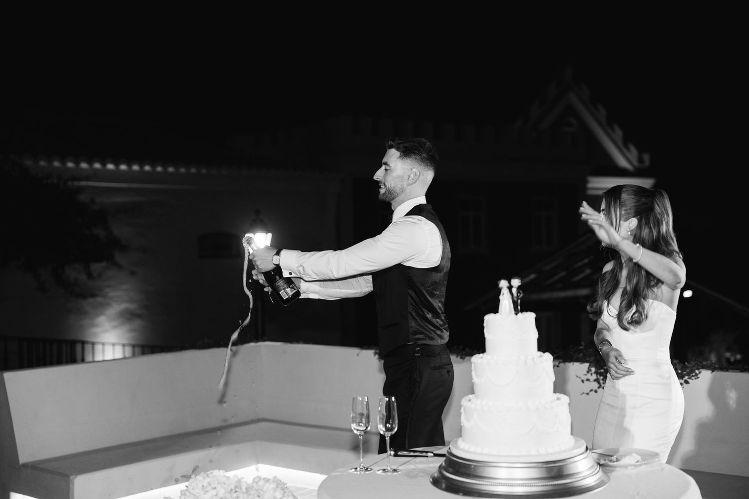 Wedding reception scene showing cake cutting and champagne toasting moments.