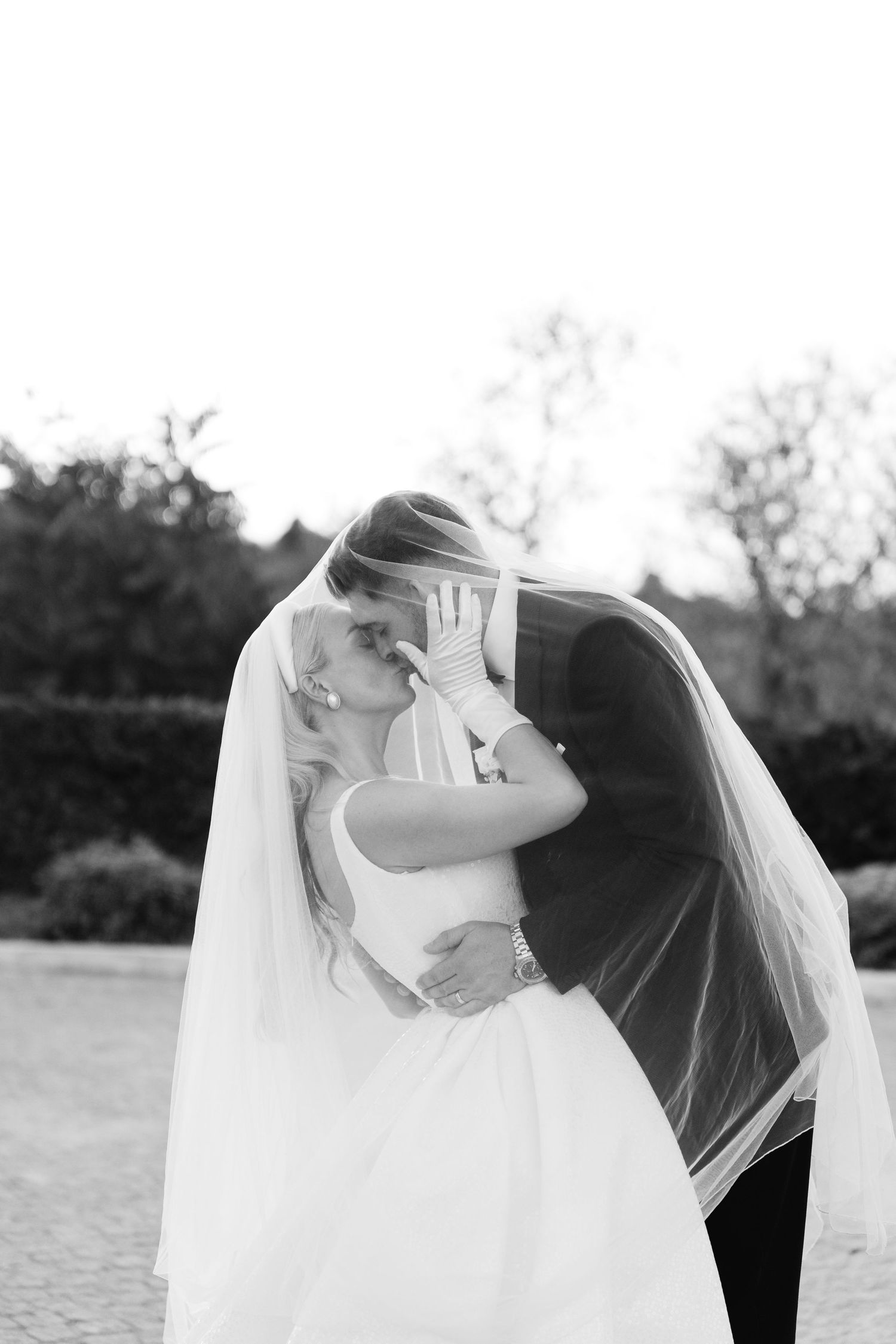 Black and white wedding photography sequence showing a romantic dip pose.