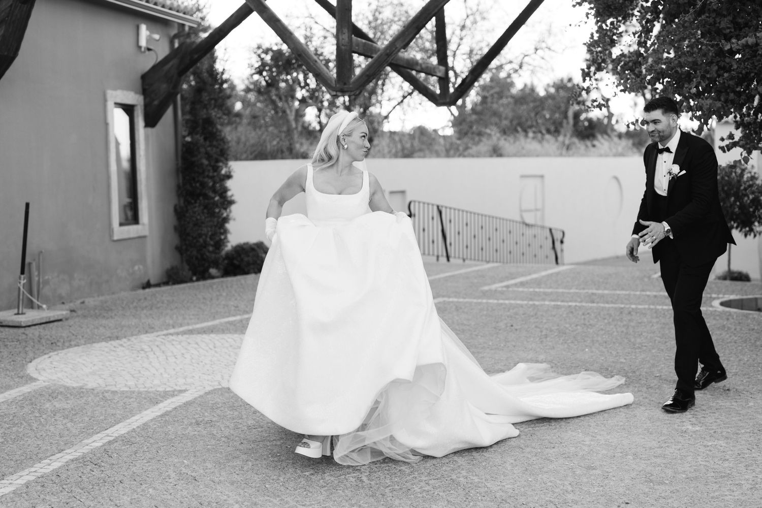Black and white photo of a wedding celebration on an elegant outdoor terrace.