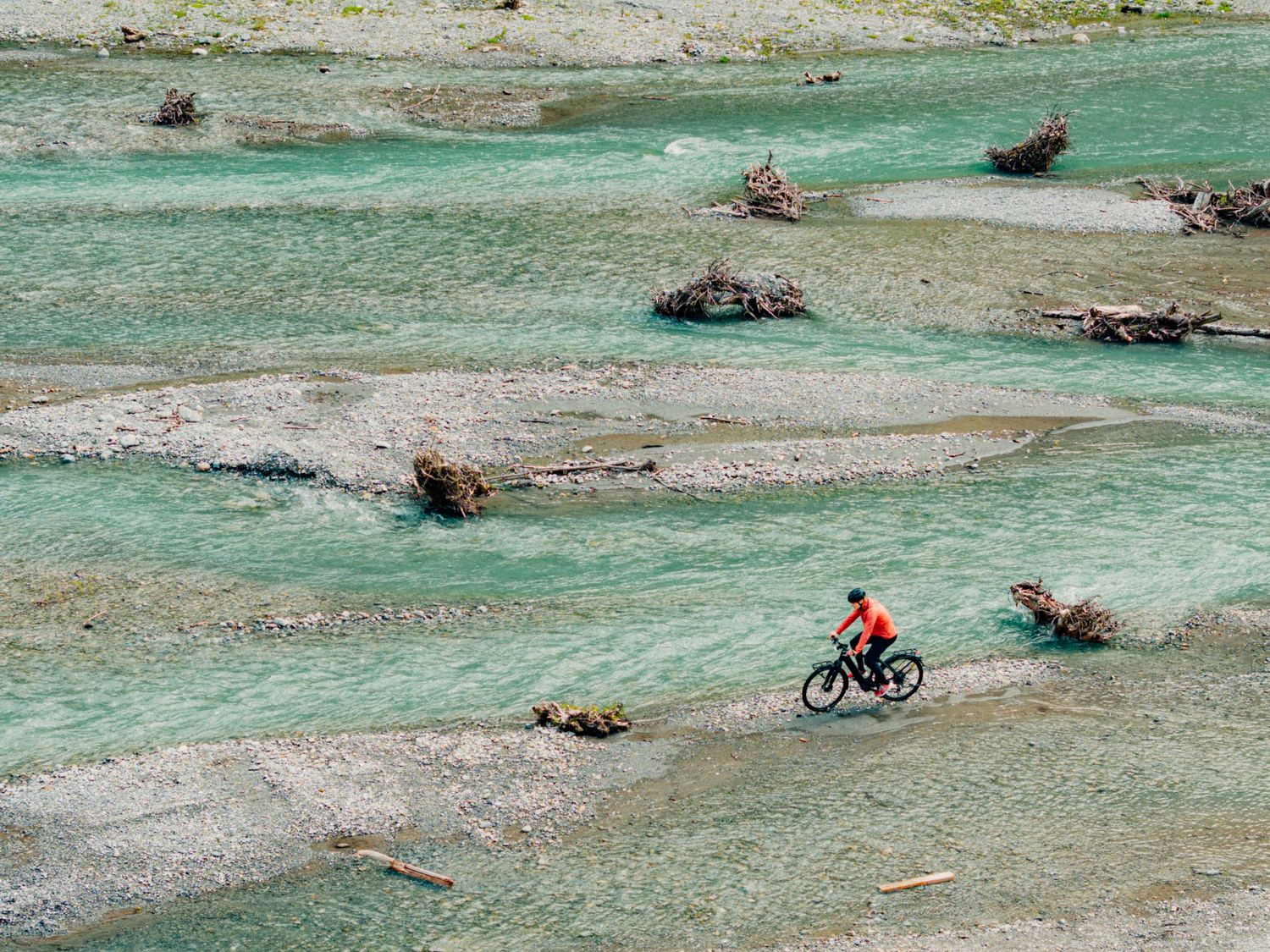 Marco Odermatt crossing rivers in his hometown riding on his Miloo electric bike. Captured by Fabiano Mancesti