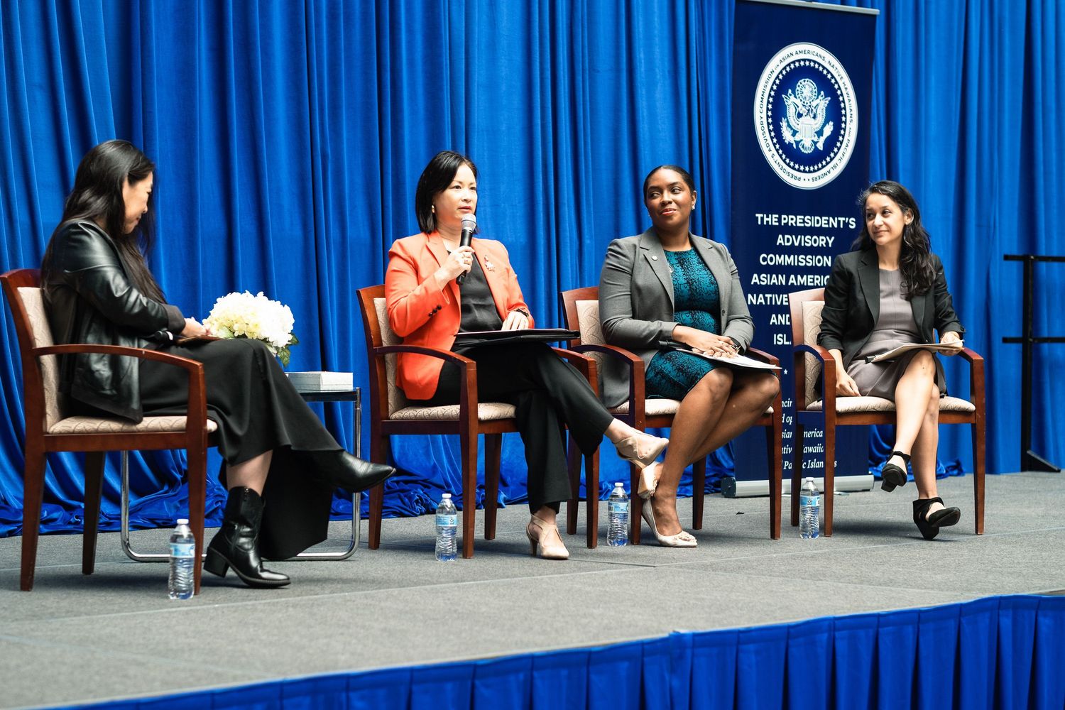 Four women participate in a panel discussion at a Presidential Advisory Commission on Asian Americans event.