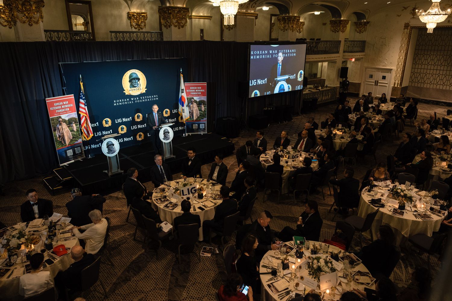 Overhead view of formal Korean War Veterans Memorial Foundation gala dinner with round tables.