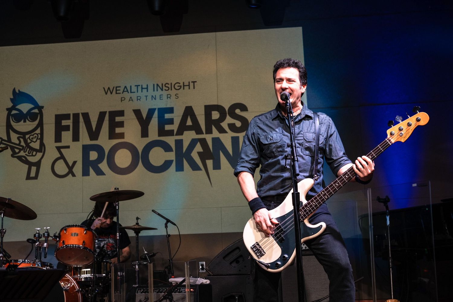 Guitarist performs on stage at Wealth Insight Partners Five Years & Rockin anniversary event celebration.