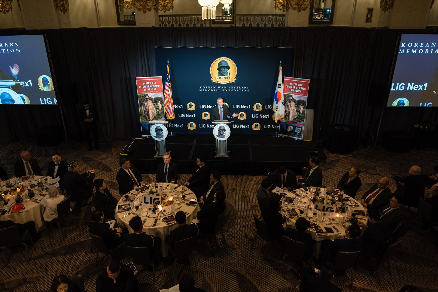Aerial view of Korean War Veterans Memorial Foundation gala dinner with guests seated at round tables.