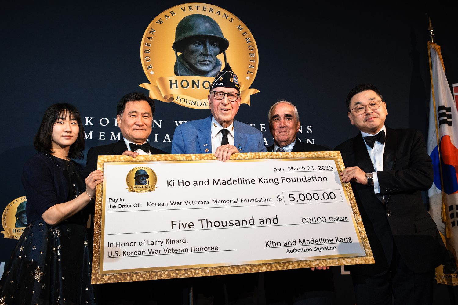 Group presenting a $5,000 check to Ki Ho and Madeline Kang Foundation at Korean War Veterans Memorial event.
