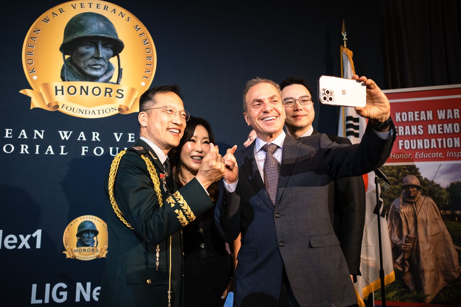 Group takes a selfie at Korean War Veterans Memorial Foundation Honors event with military officer.