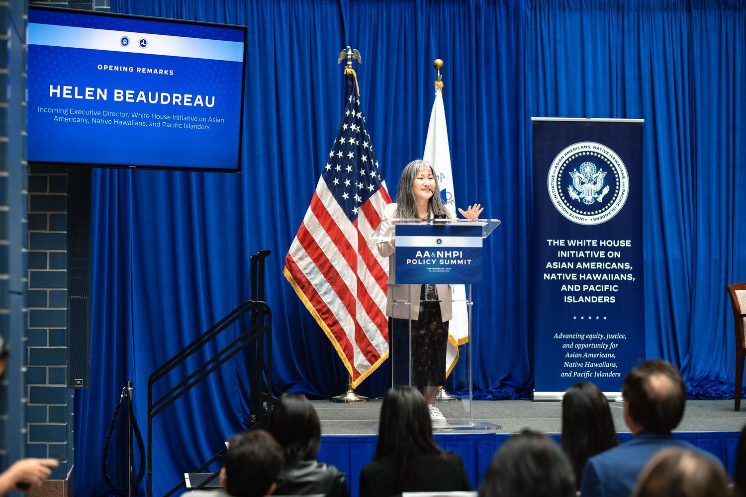 Helen Beaudreau speaks at podium during AA NHPI White House Initiative Policy Summit event.
