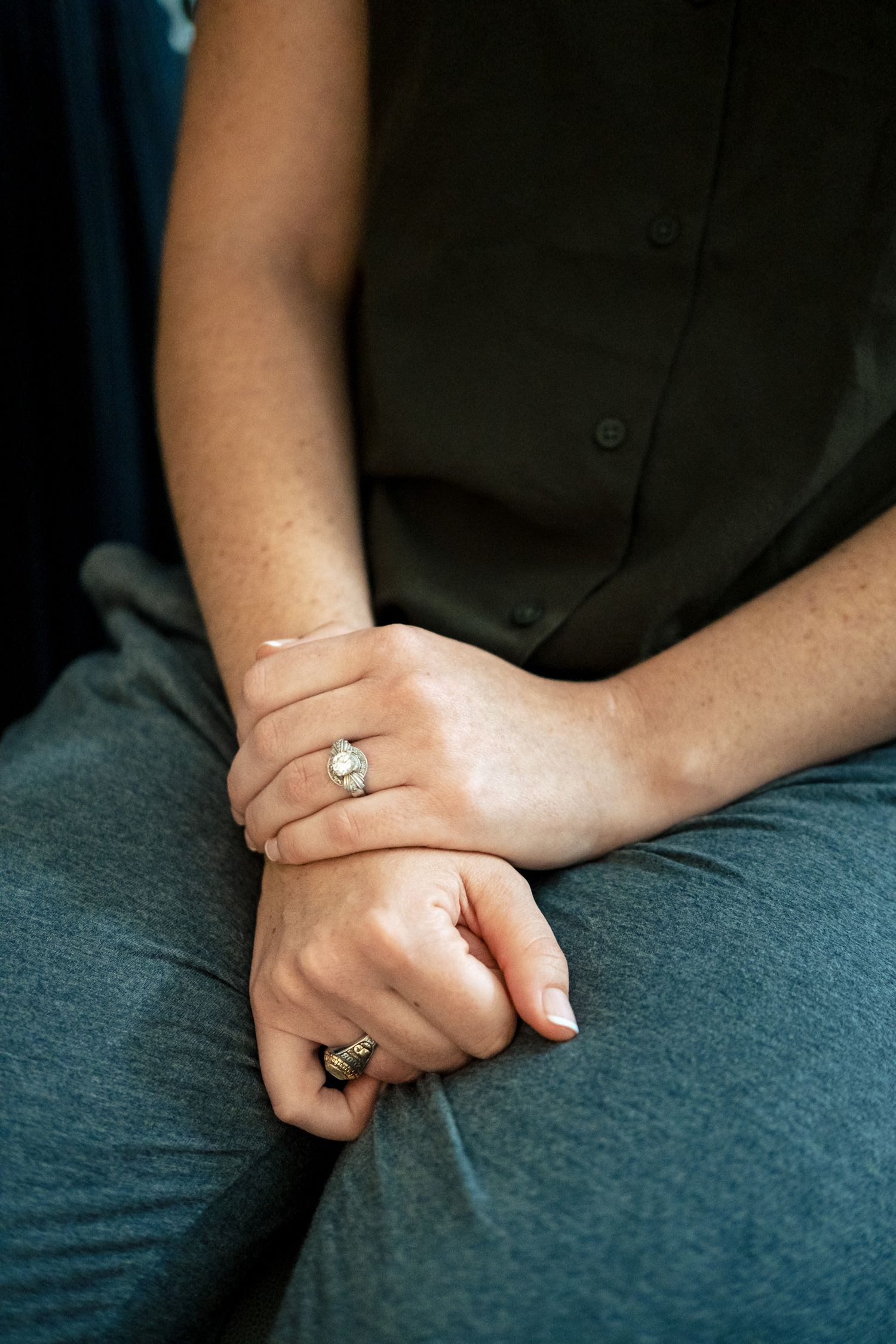 Close-up of bride's hands with sparkling diamond engagement ring before wedding ceremony.