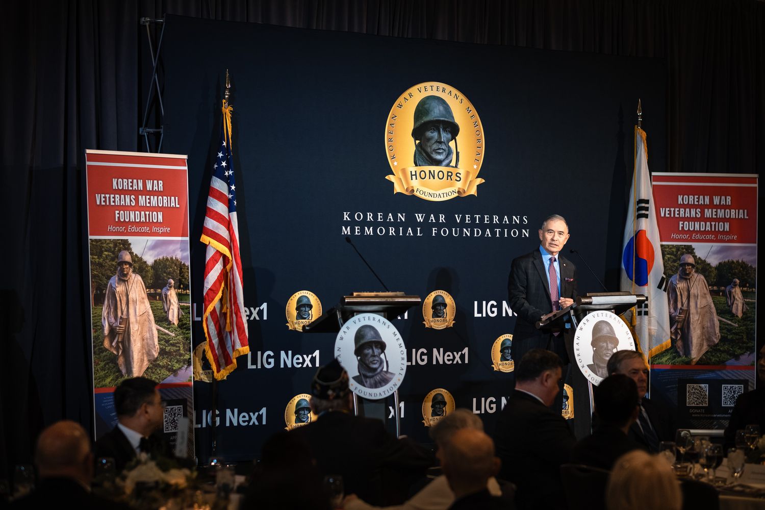 Speaker addresses seated guests at Korean War Veterans Memorial Foundation formal awards dinner gala.