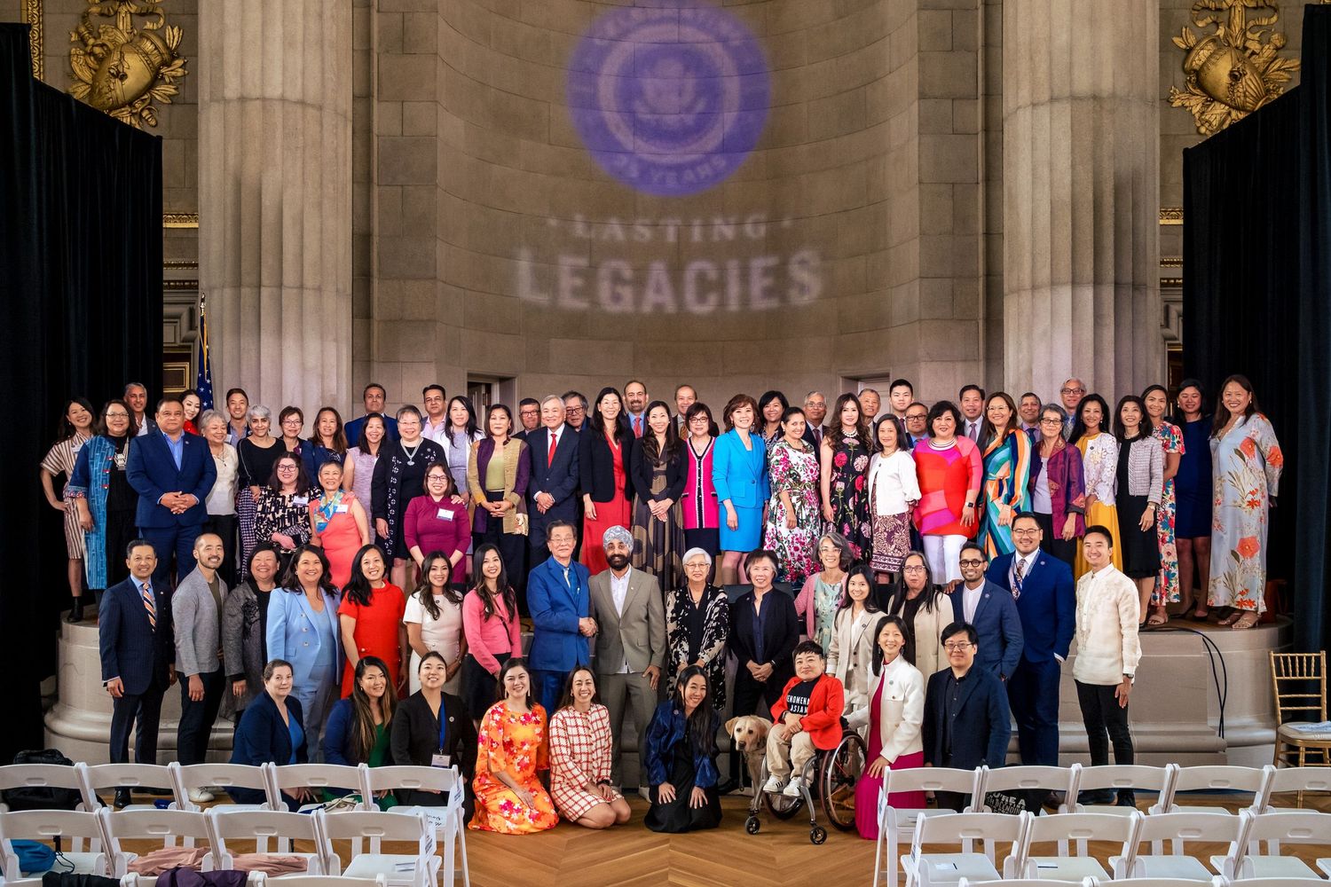 Large group photo at Lasting Legacies event, diverse attendees posing together in elegant venue.