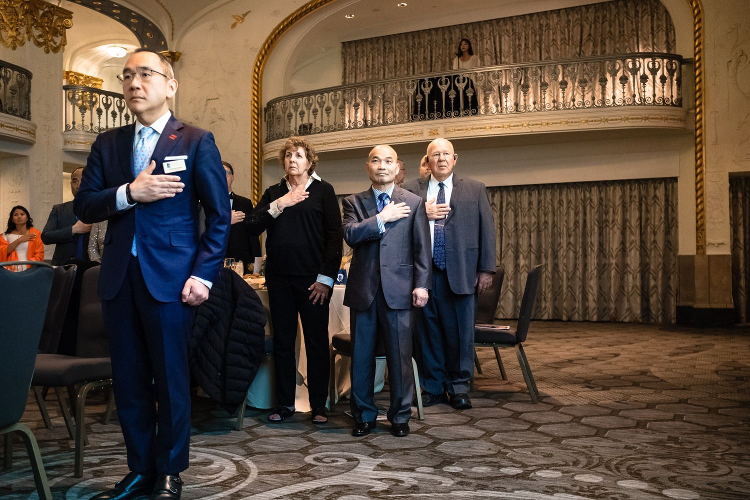 Group of attendees standing at attention during a Korean War Veterans Memorial Foundation formal gala event.