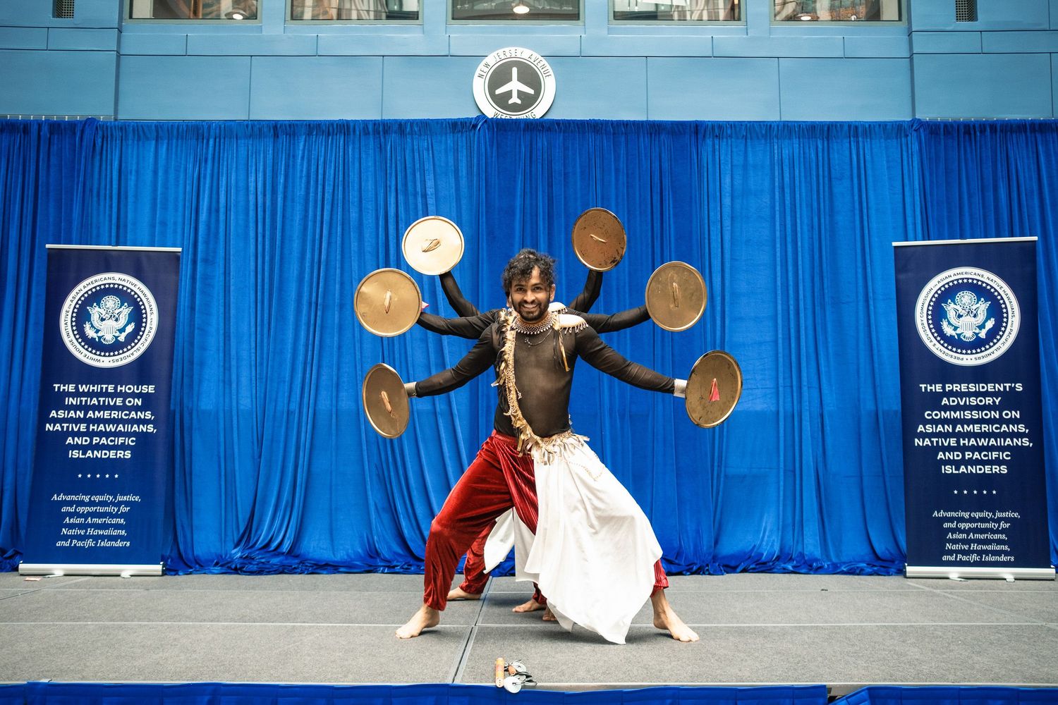 Traditional dancer performs multi-arm Kandyan dance at White House Asian American and Pacific Islander event.