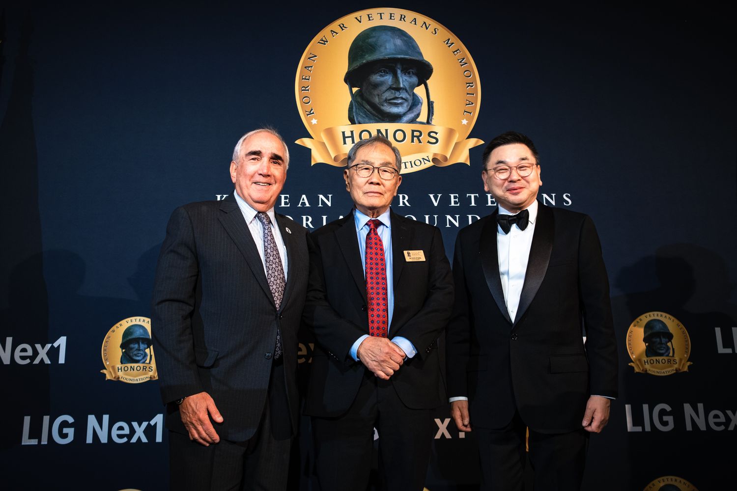 Three men posing together at the Korean War Veterans Memorial Foundation Honors gala event.