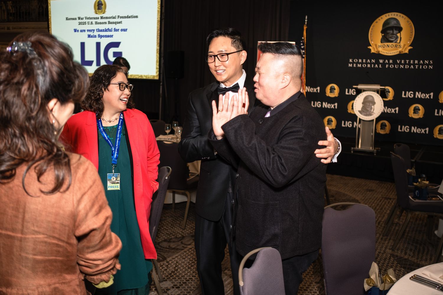 People networking at a Korean War Veterans Memorial Foundation LIG awards event in a formal venue.