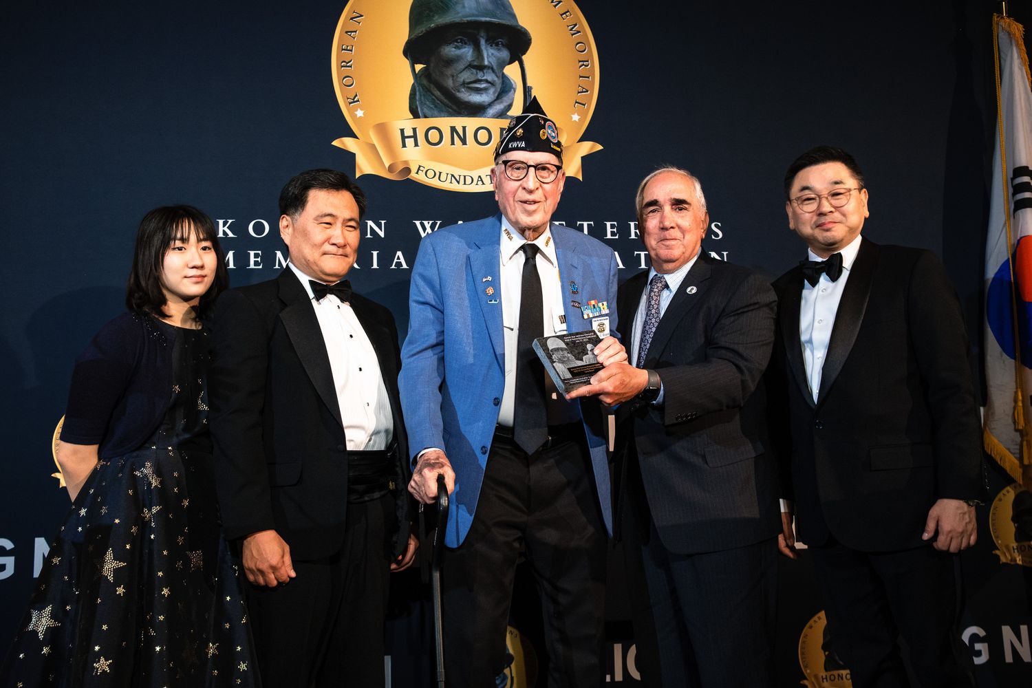 Five formally dressed attendees pose together at Korean War Veterans Memorial Foundation honor gala event.