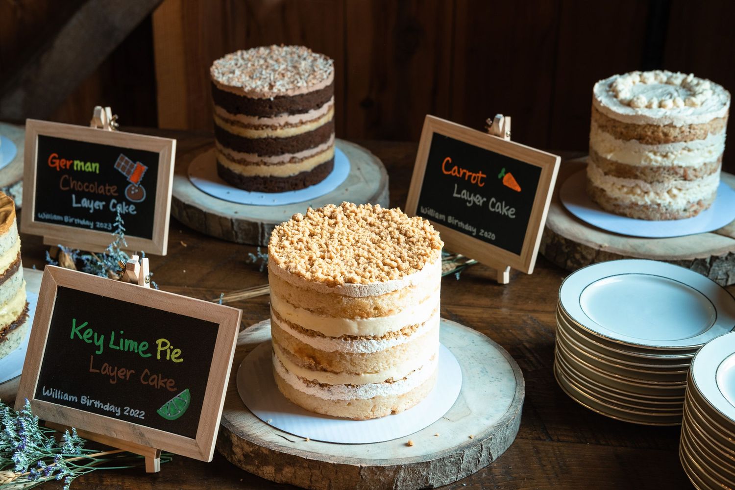 Rustic wedding dessert table with key lime pie, carrot, and German layer cakes.