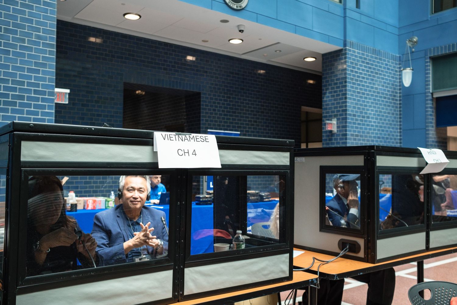 Interpreter booths with Vietnamese channel 4 sign at a multilingual conference event.
