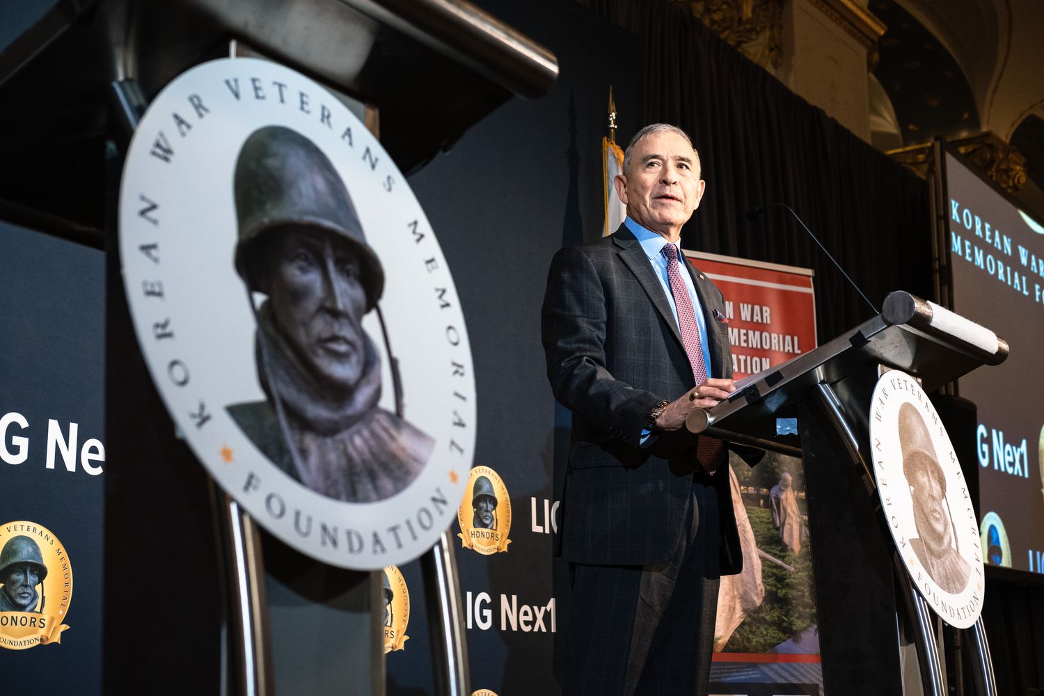Male speaker addresses guests at Korean War Veterans Memorial Foundation awards ceremony gala event.
