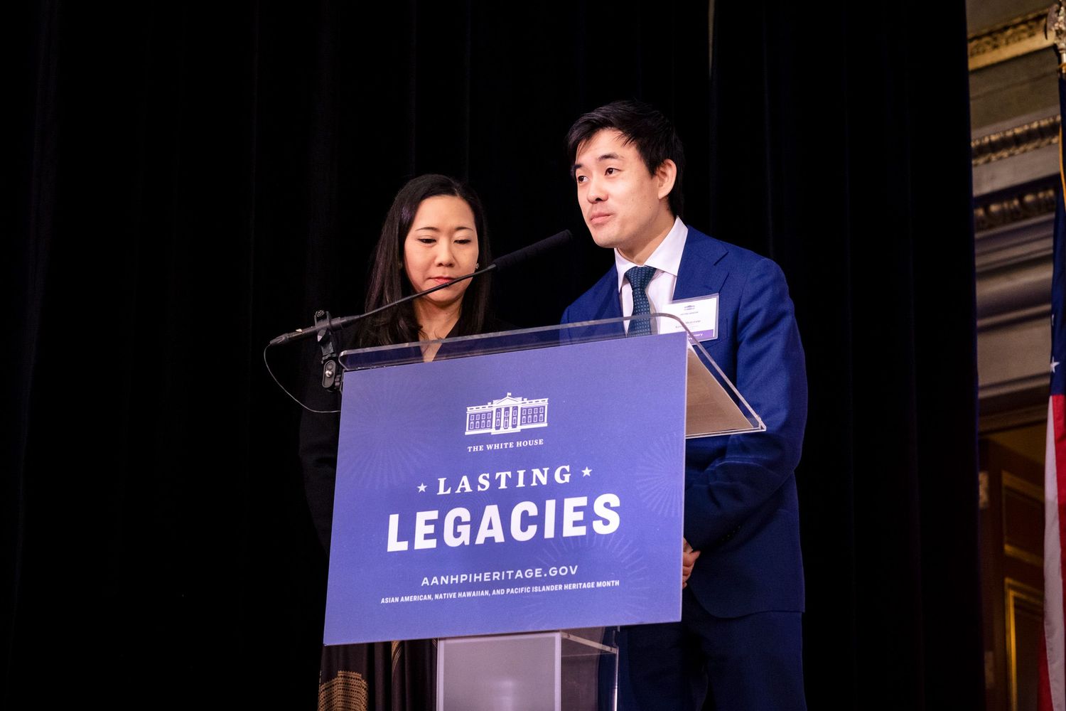 Two speakers present at a Lasting Legacies podium during a formal awards ceremony.