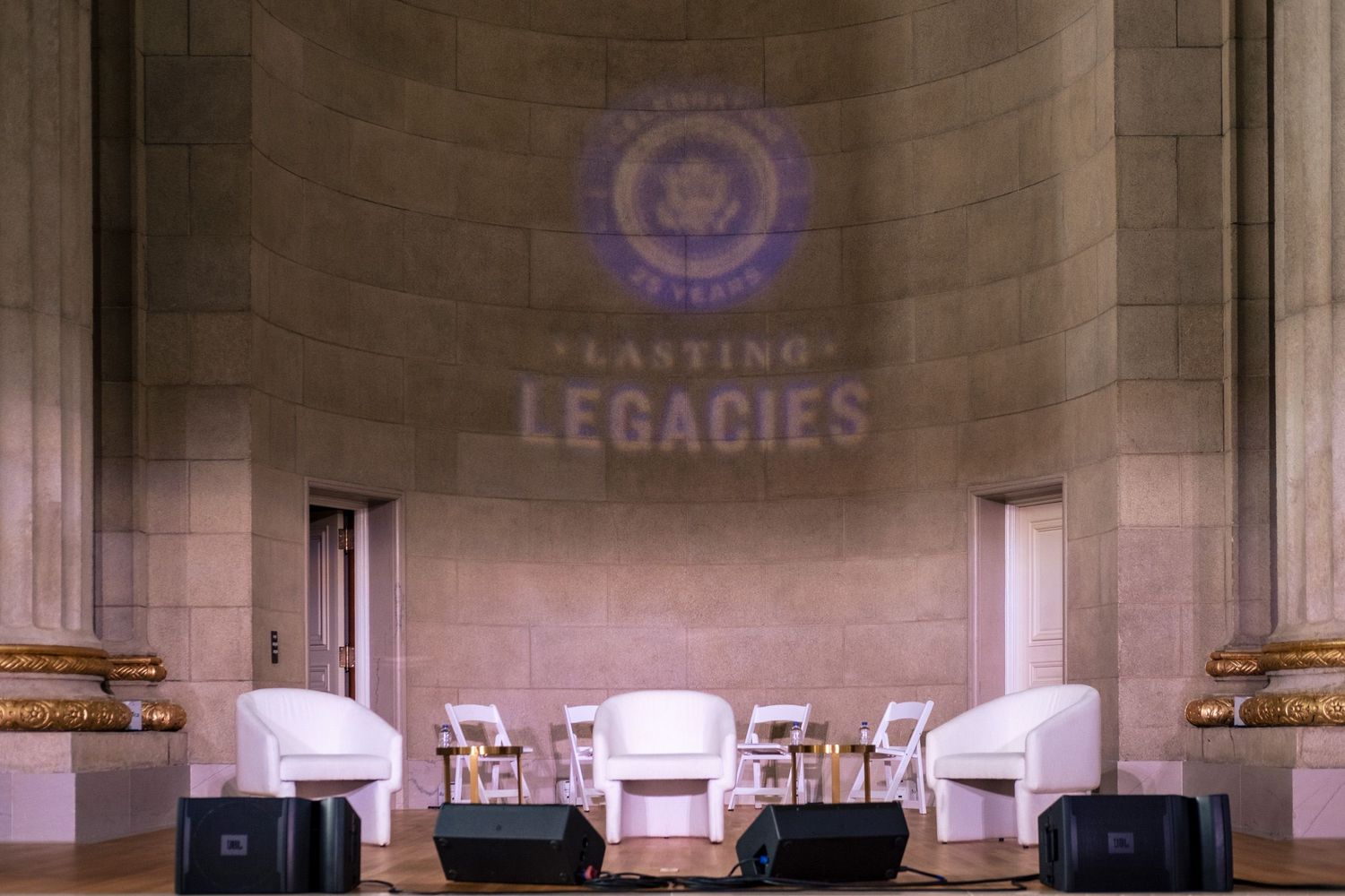 Elegant event stage with white chairs and 