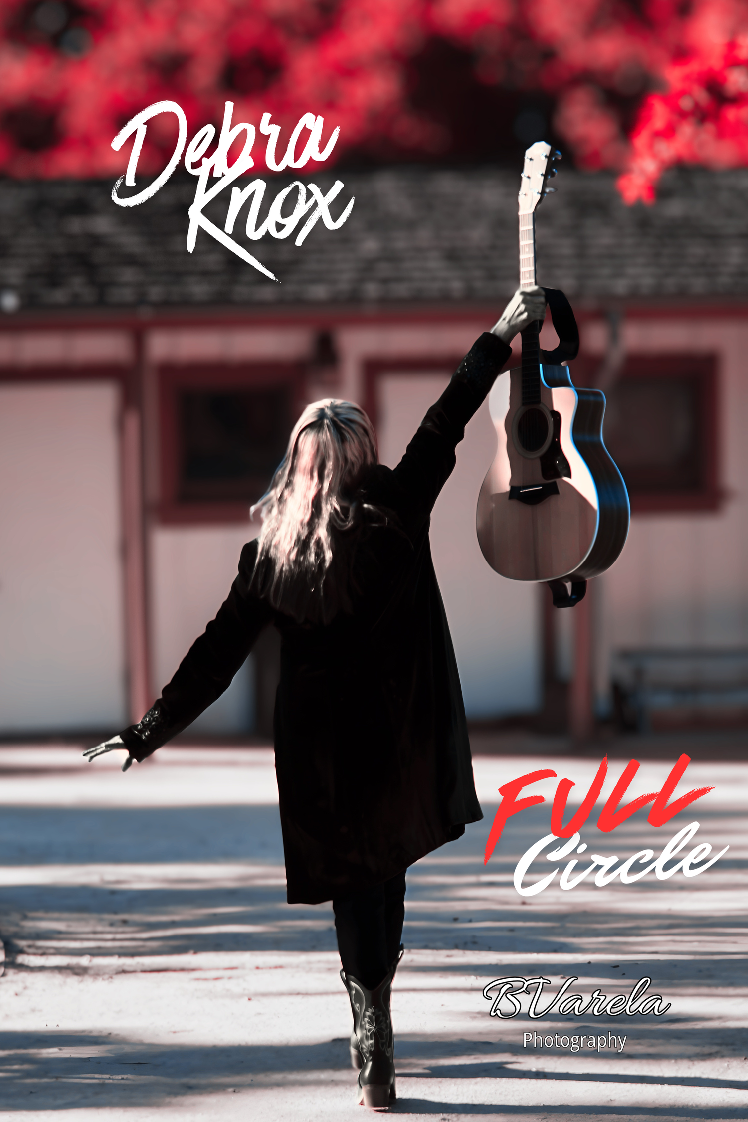 Debra Knox holding guitar overhead walking away, Full Circle album cover with red foliage background.