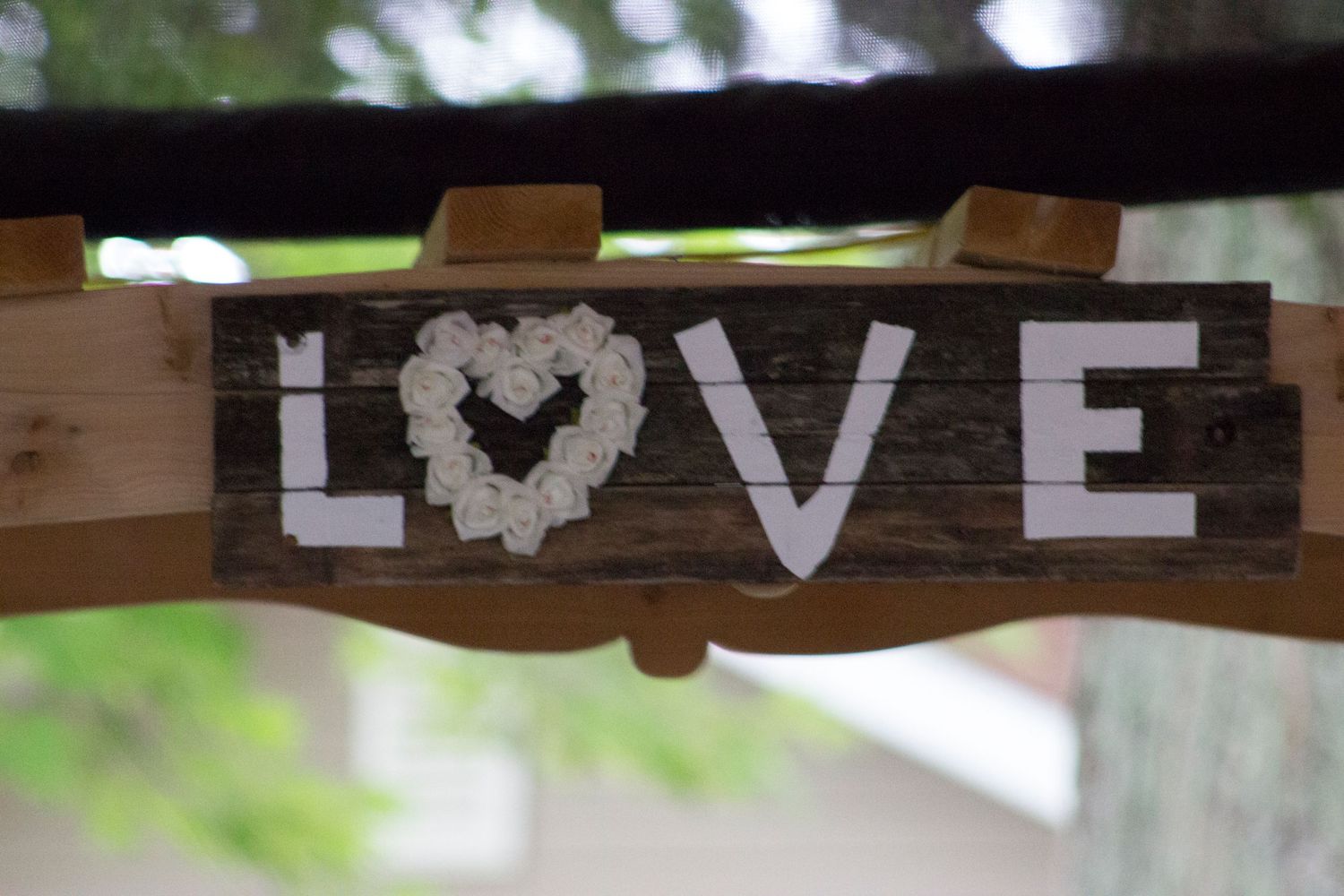 Wood sign that reads Love