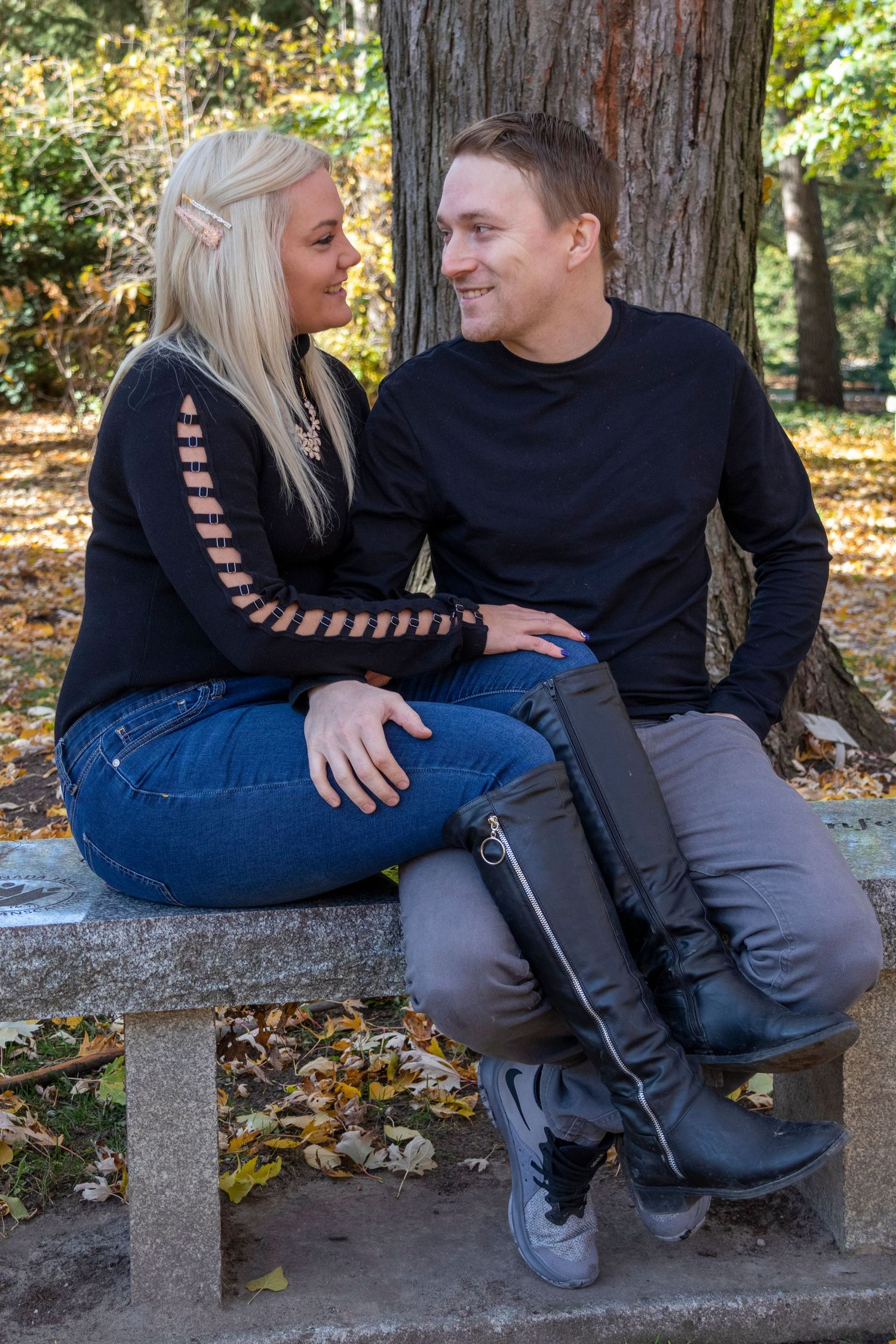 Engaged couple looking at each other sitting on a bench