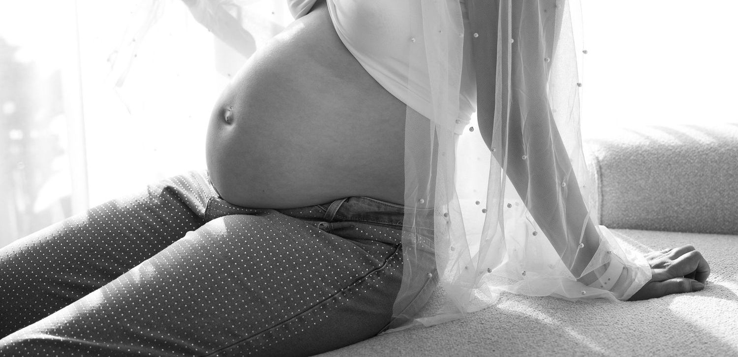 Black and white image of pregnant belly.
