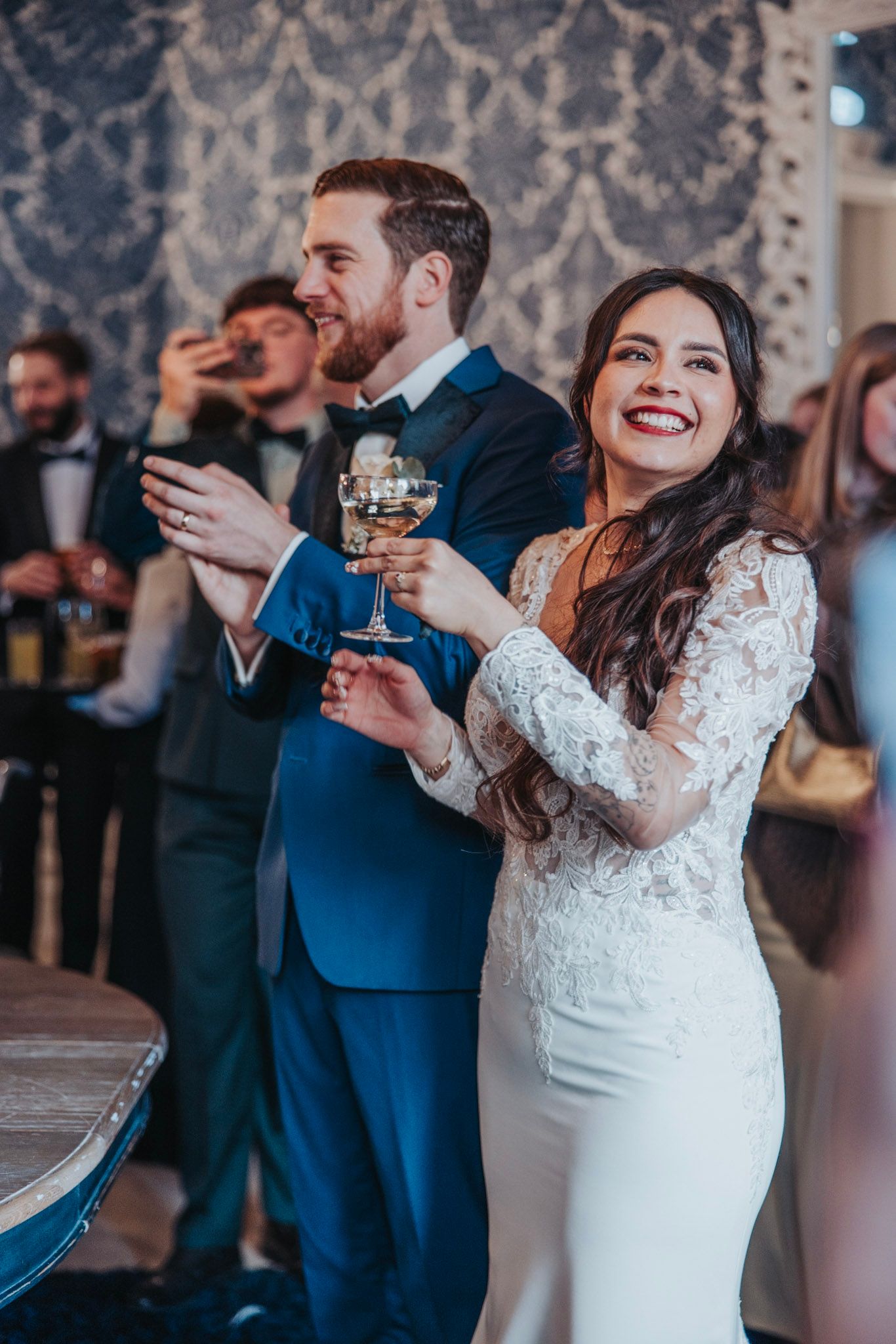 Bridal couple laughing and toasting during their wedding reception in Landgoed Huis De Voorst