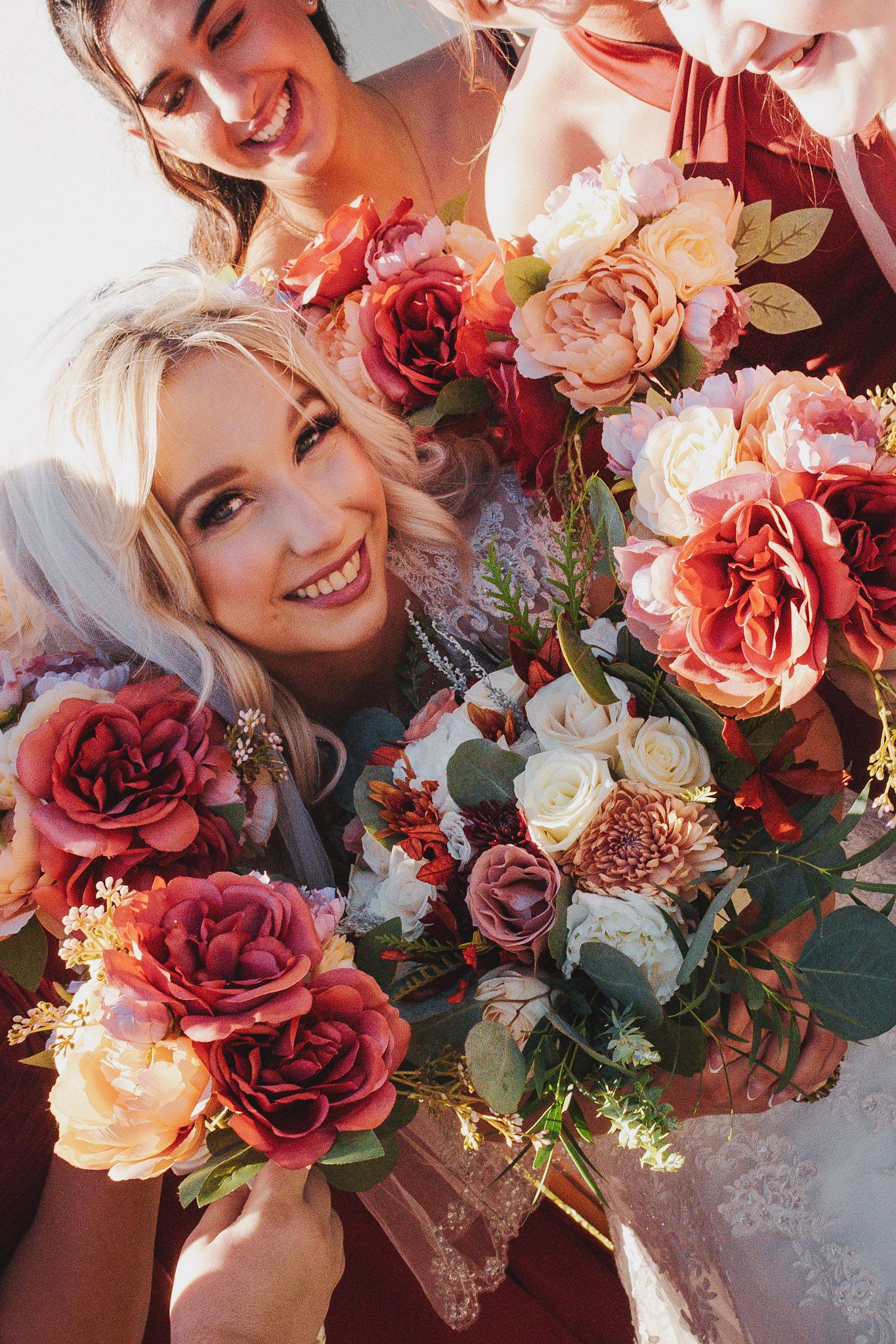 A collage of wedding bouquets featuring blush and burgundy roses with greenery in a romantic garden style arrangement.