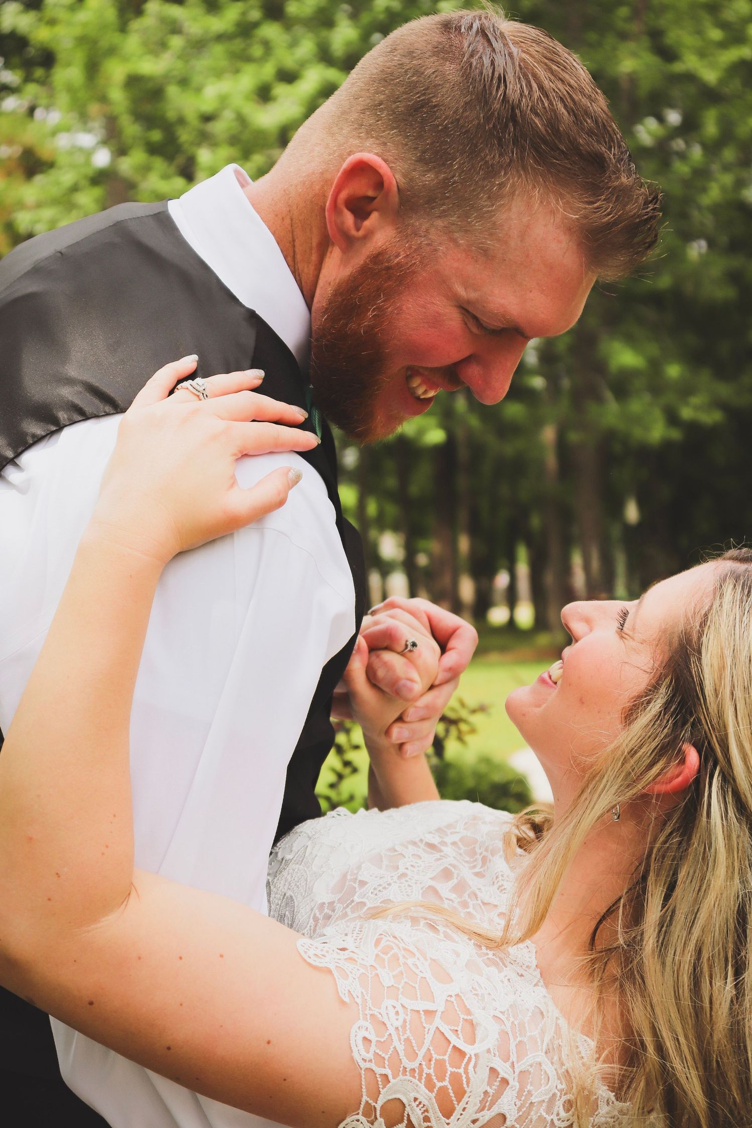 Romantic outdoor wedding photo sequence showing couple in white attire sharing intimate moments in a garden setting.