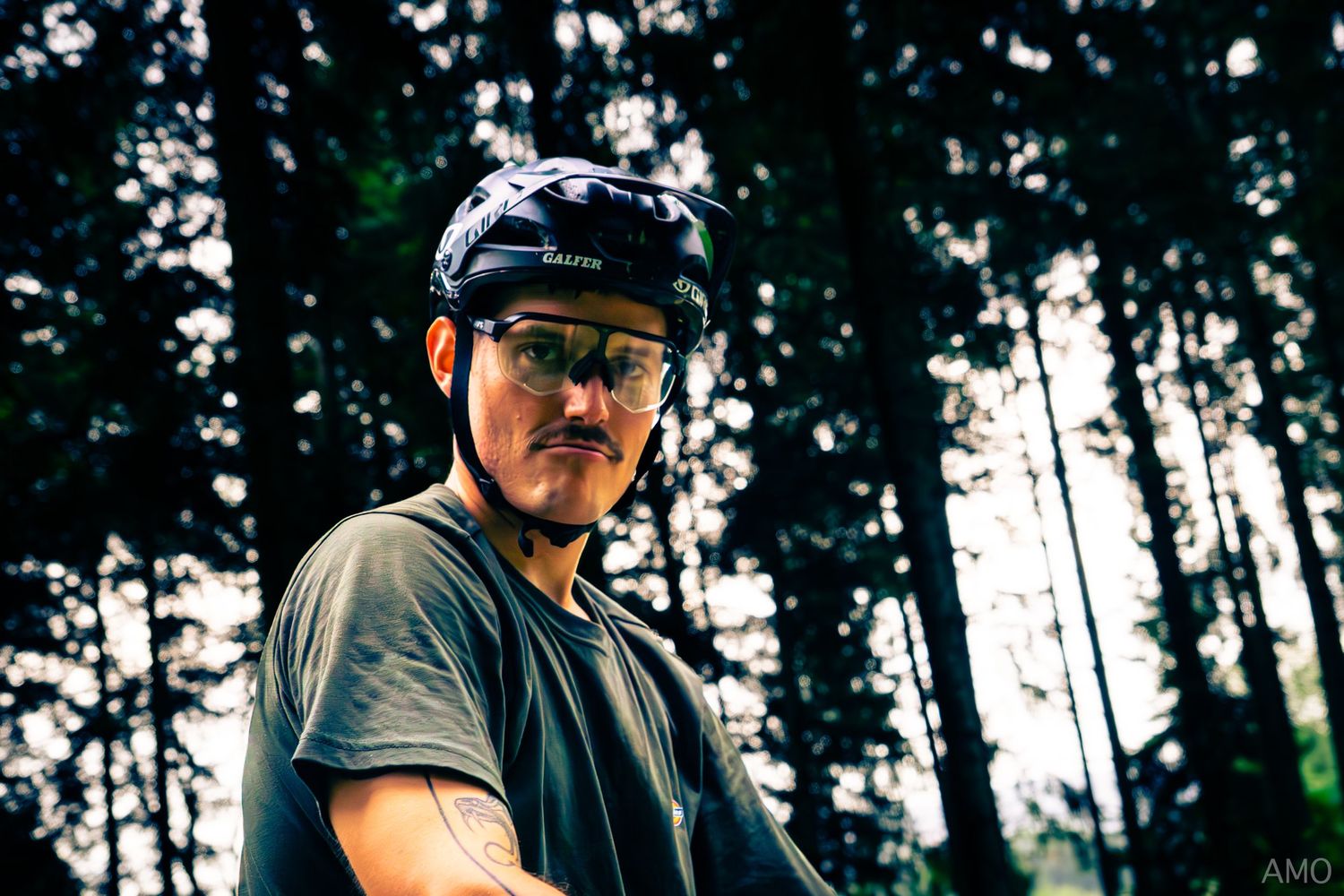 Close-up portrait of mountain biker in forest setting.