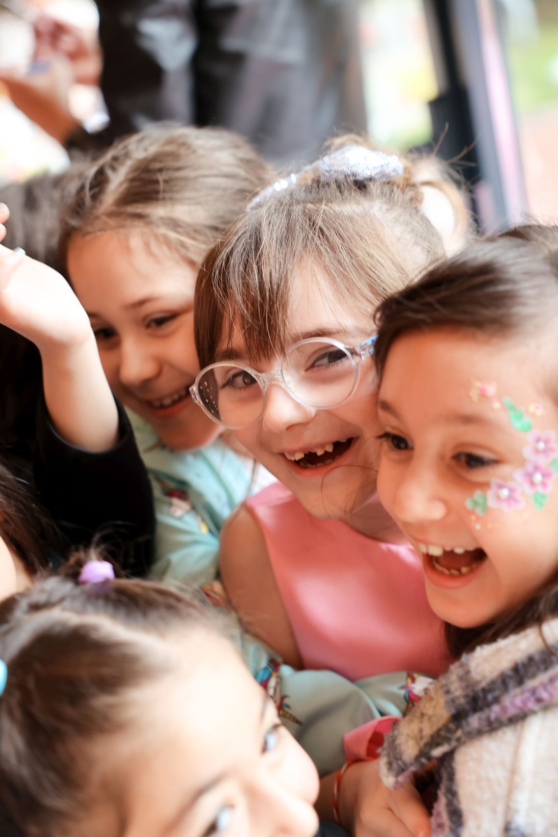 Close-up shot of excited young partygoers smiling and laughing together.
